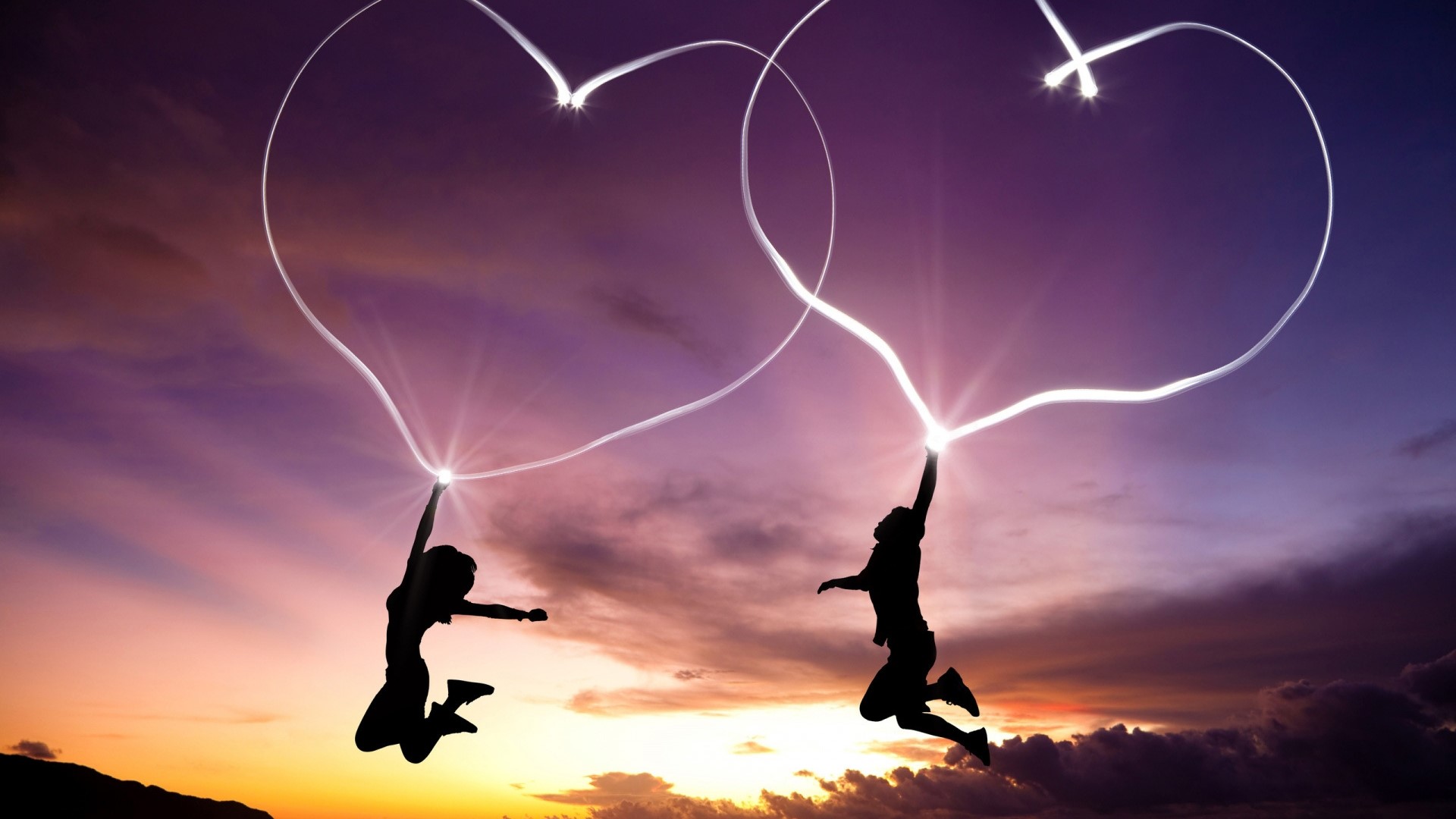 Couple drawing hearts in the sky at sunset HD Wallpaper