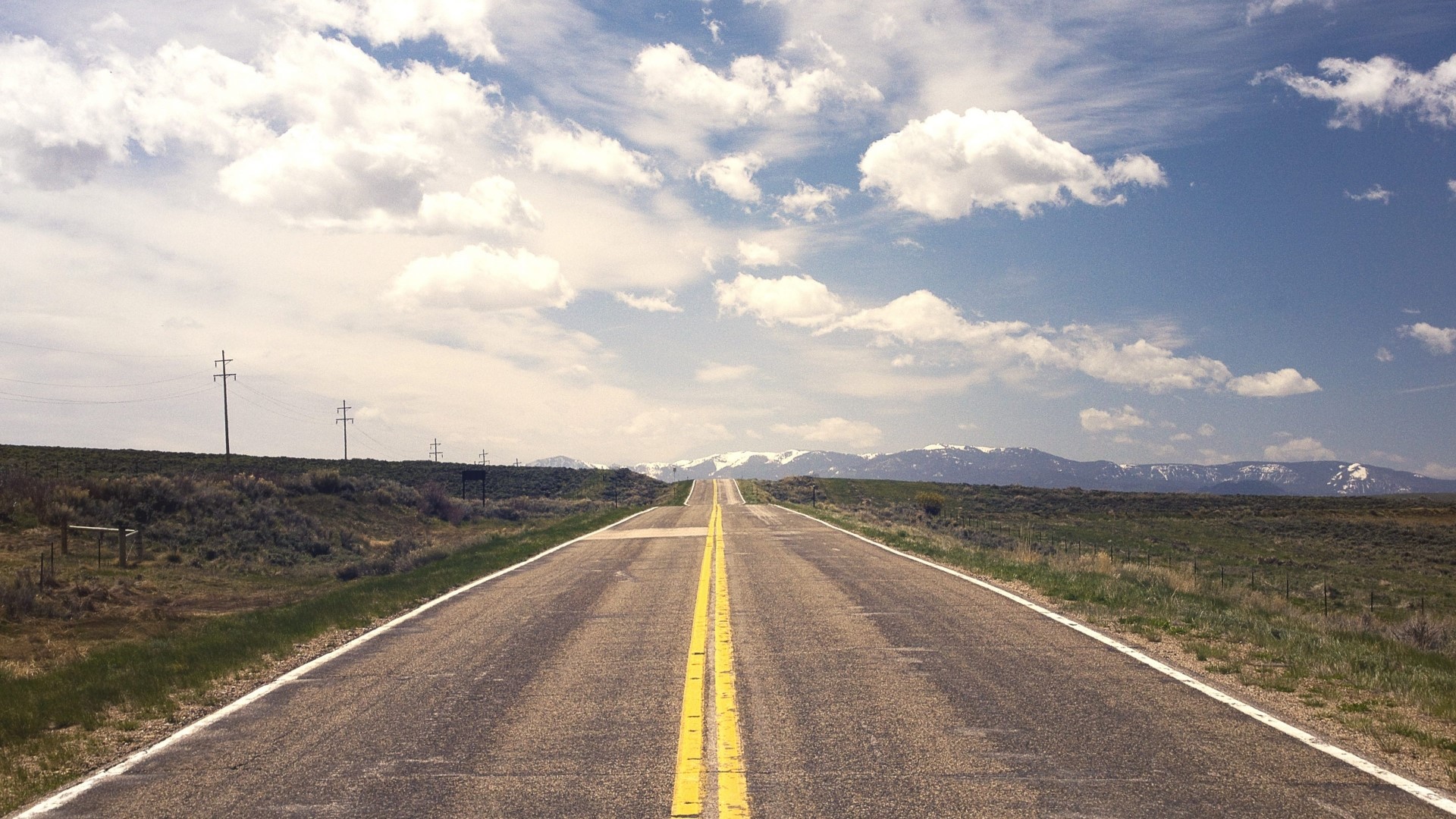 Open road with mountains and clouds HD Wallpaper