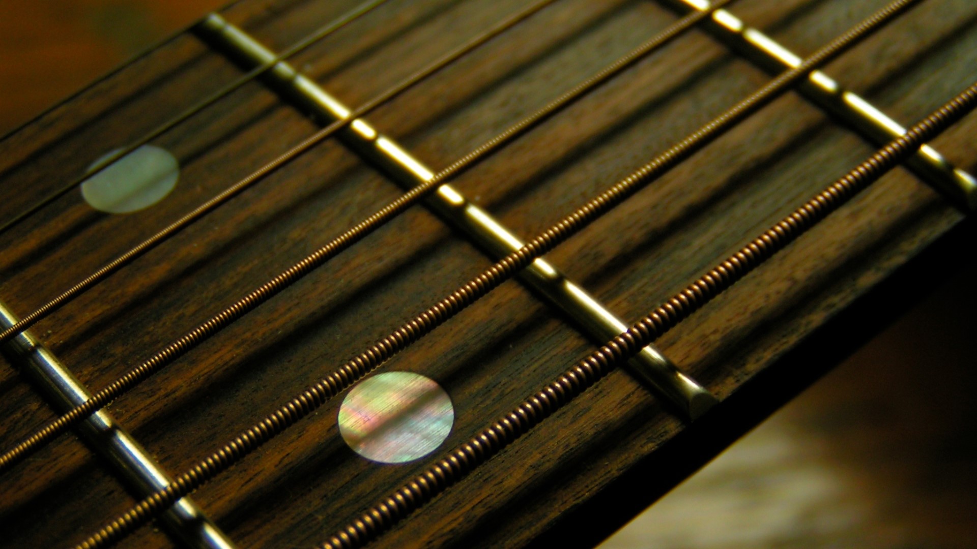 Close up of a guitar neck with strings and frets HD Wallpaper