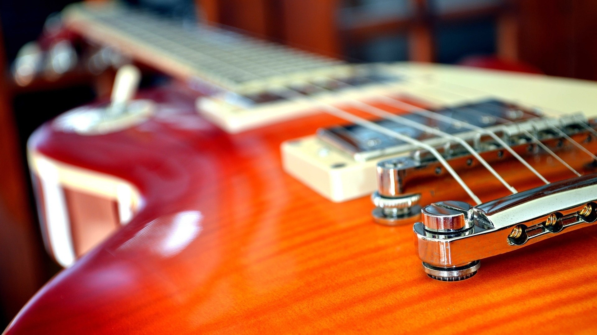 Close-up of a red and orange Les Paul guitar HD Wallpaper