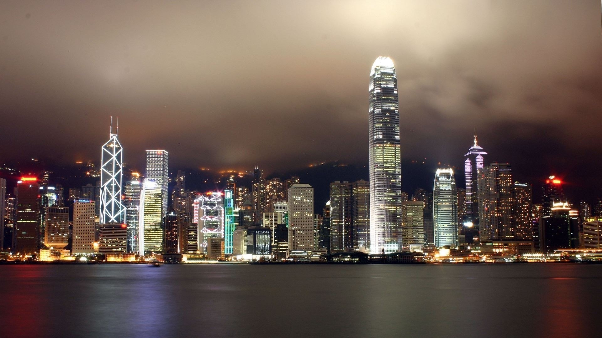 Hong Kong cityscape at night with illuminated skyscrapers HD Wallpaper
