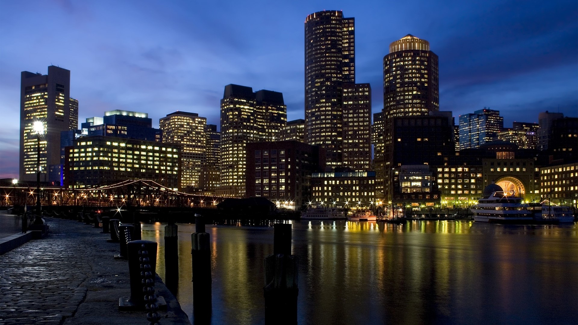Night cityscape with illuminated skyscrapers and waterfront HD Wallpaper