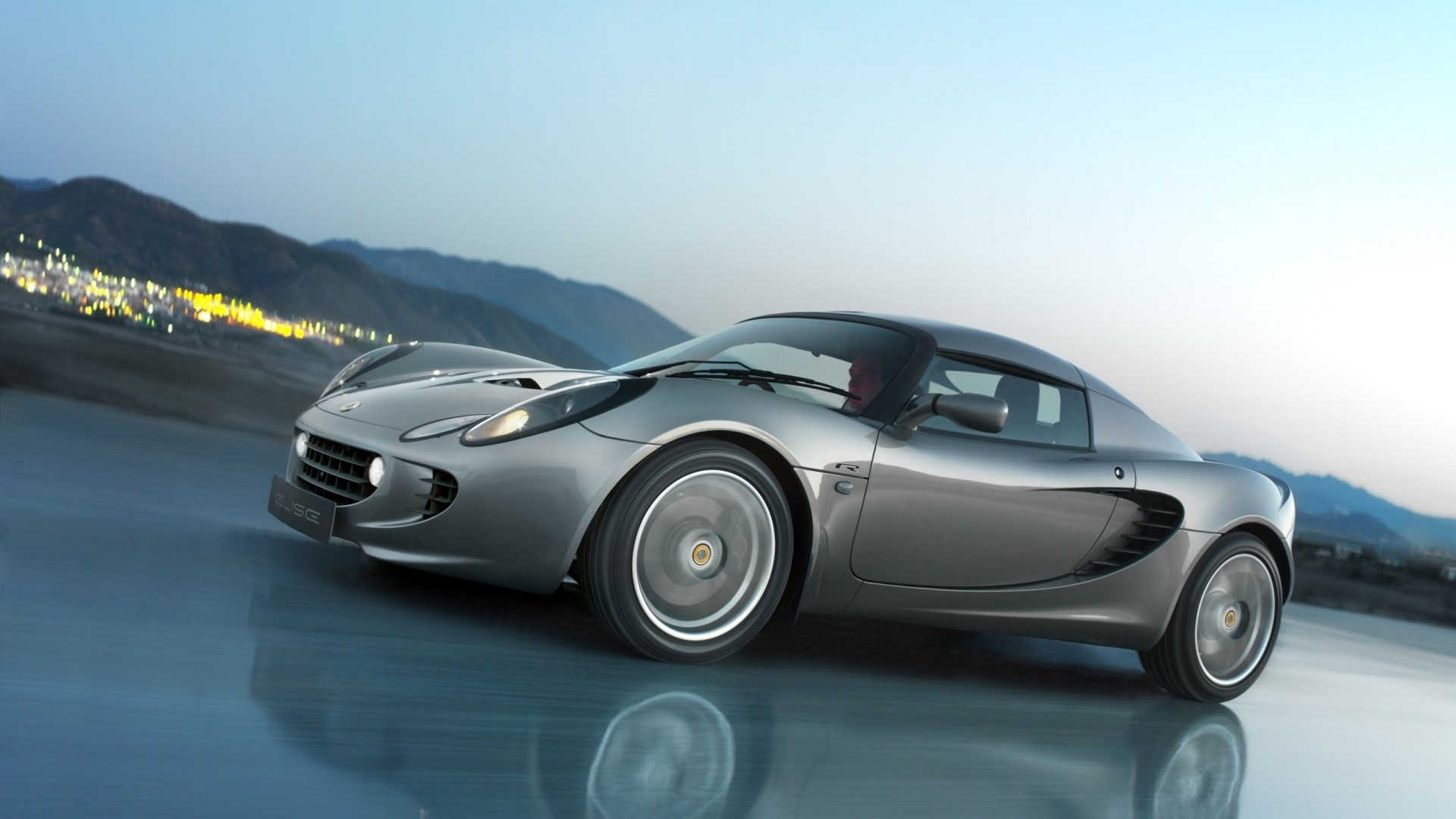 Lotus Elise S2 driving on wet road at dusk HD Wallpaper