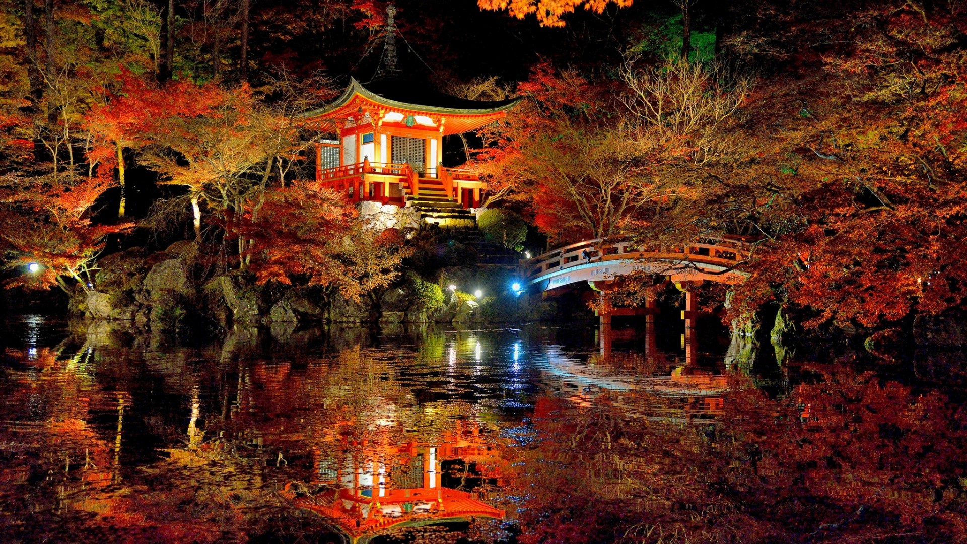 Japanese temple and bridge illuminated at night HD Wallpaper