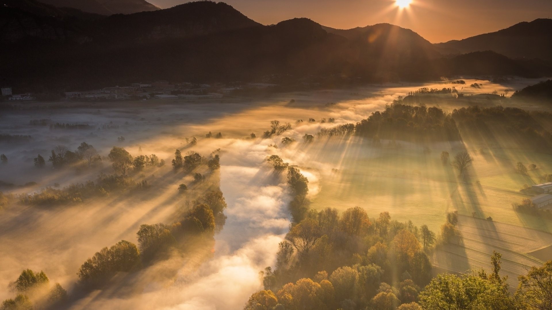 Sunset over a misty valley with mountains HD Wallpaper