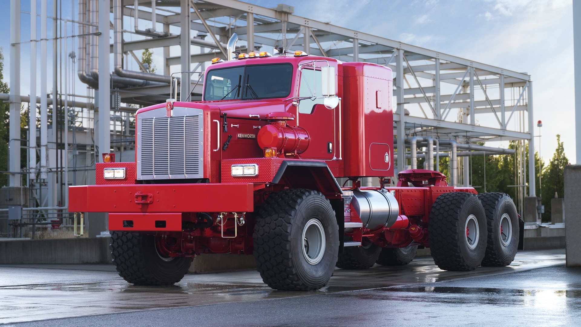 Red Kenworth Truck at Industrial Facility HD Wallpaper