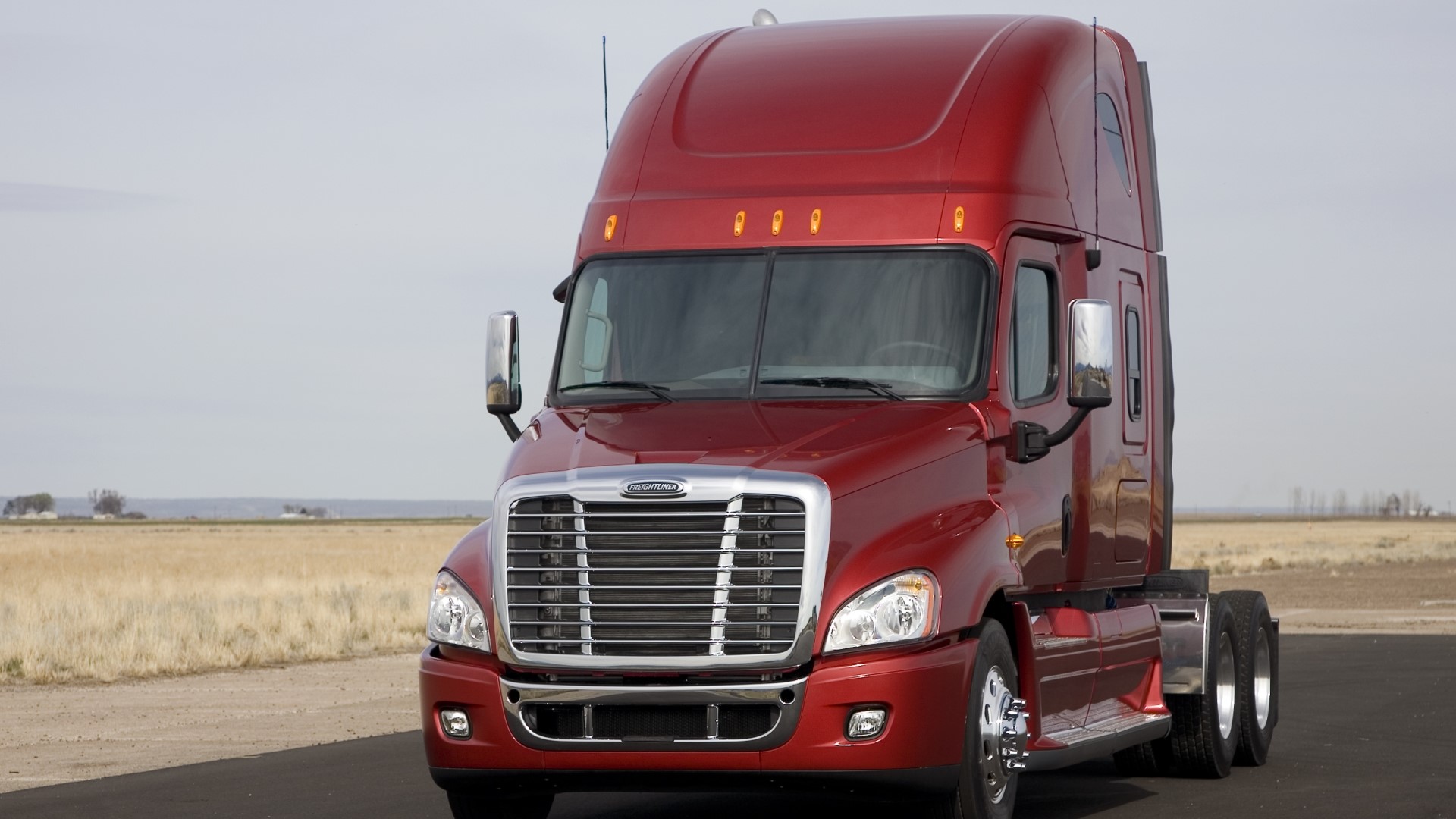 Red Freightliner Cascadia Semi-Truck on Road HD Wallpaper