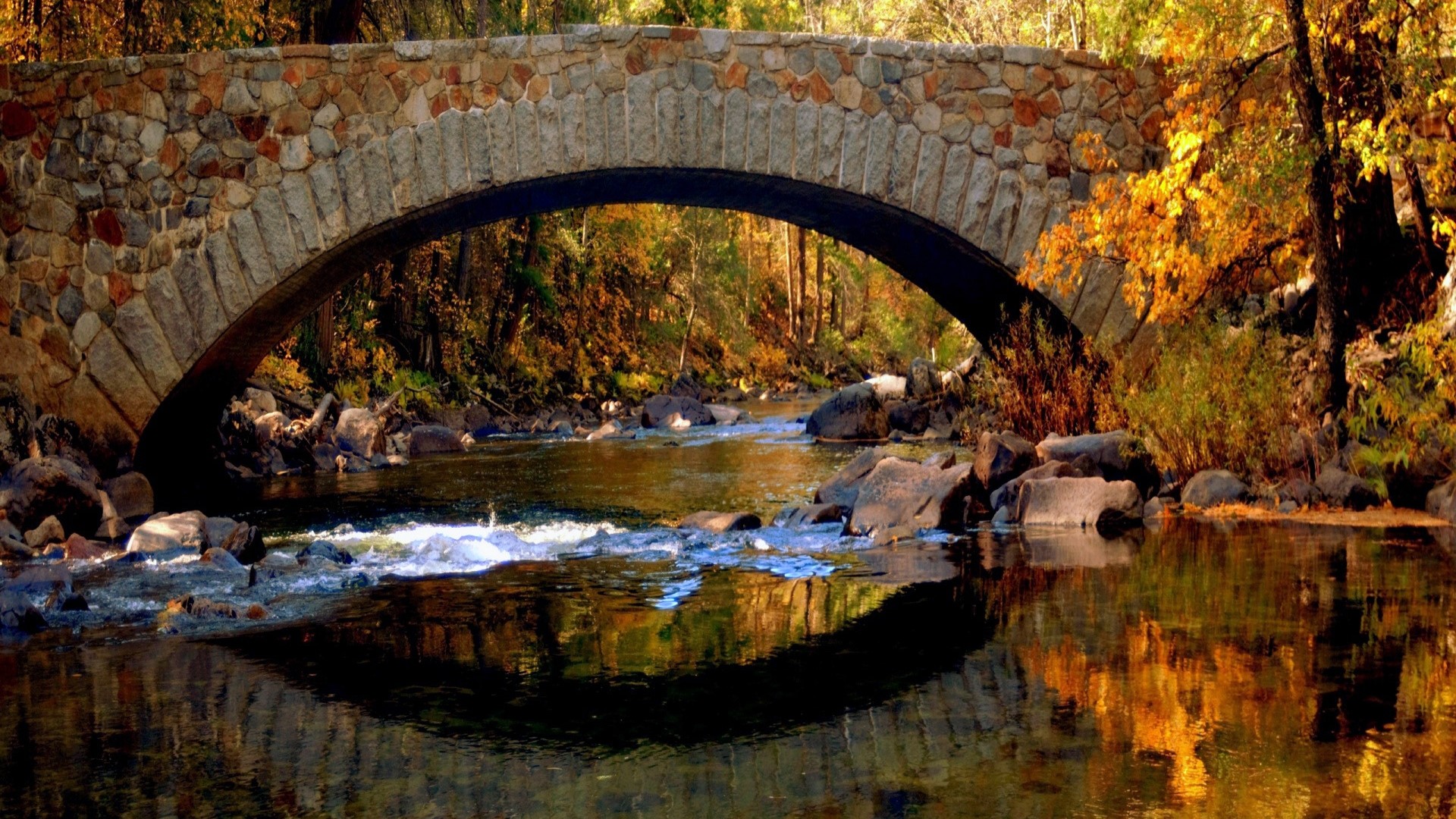 Stone bridge over a river in autumn HD Wallpaper