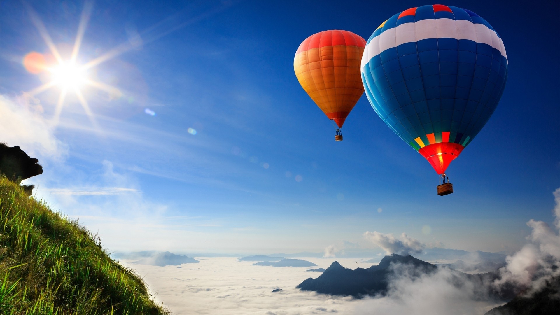 Hot air balloons flying over mountains and clouds HD Wallpaper