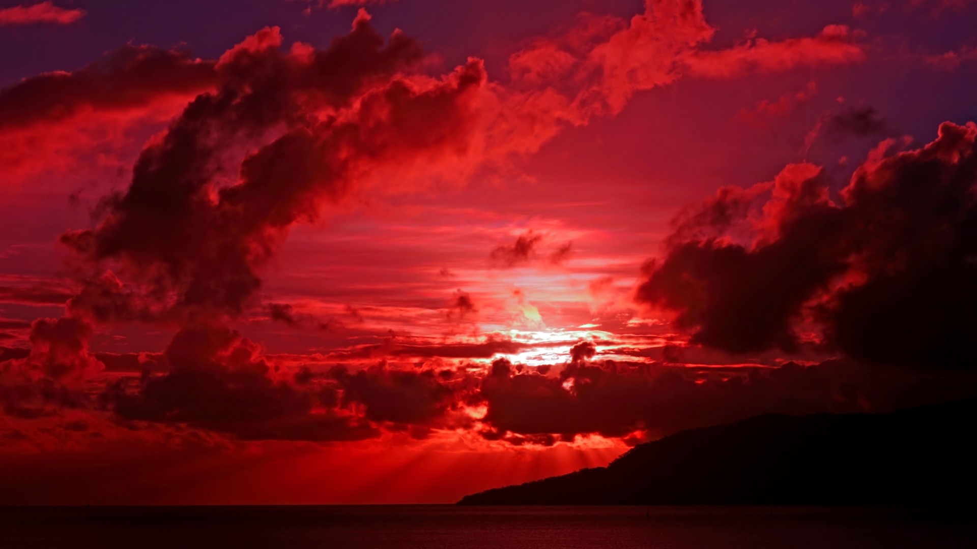 Red sunset over the ocean with clouds and island silhouette HD Wallpaper