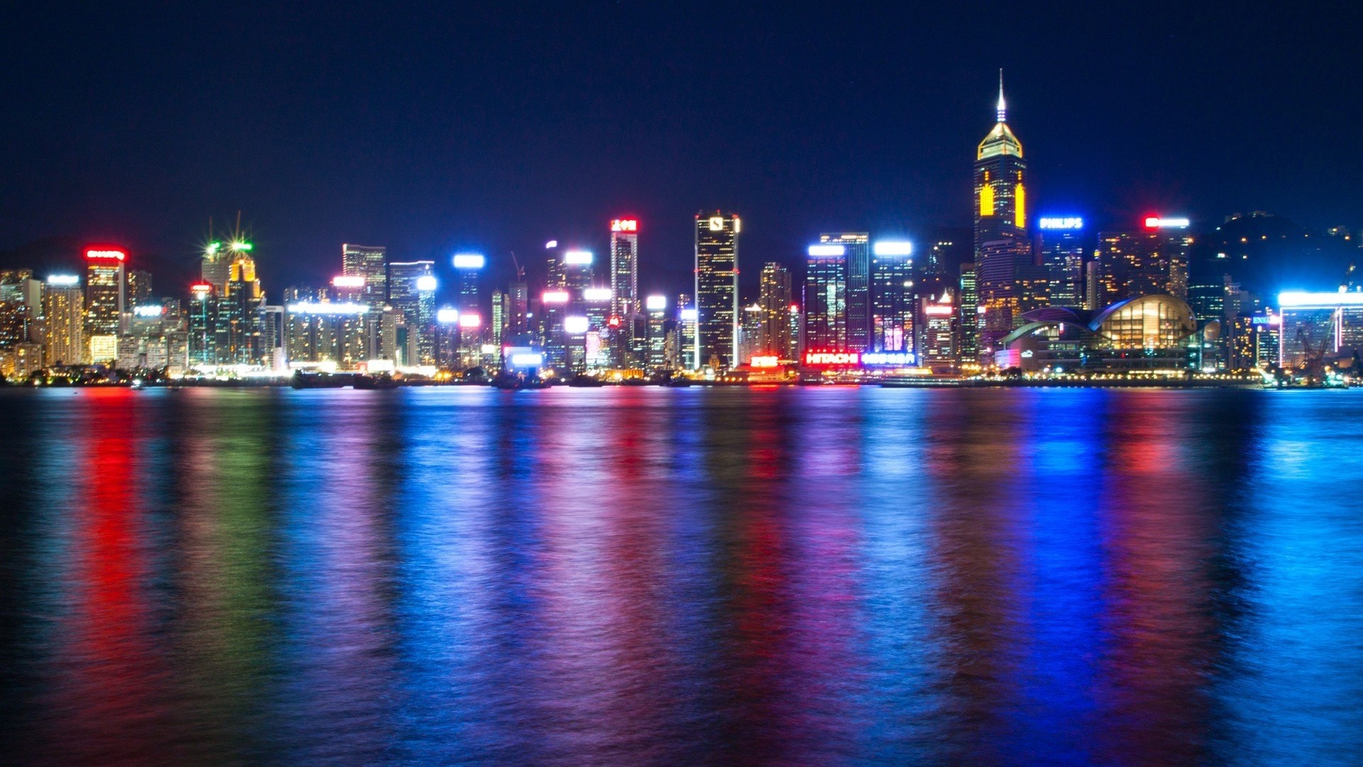 Bright Cityscape at Night with Water Reflections HD Wallpaper