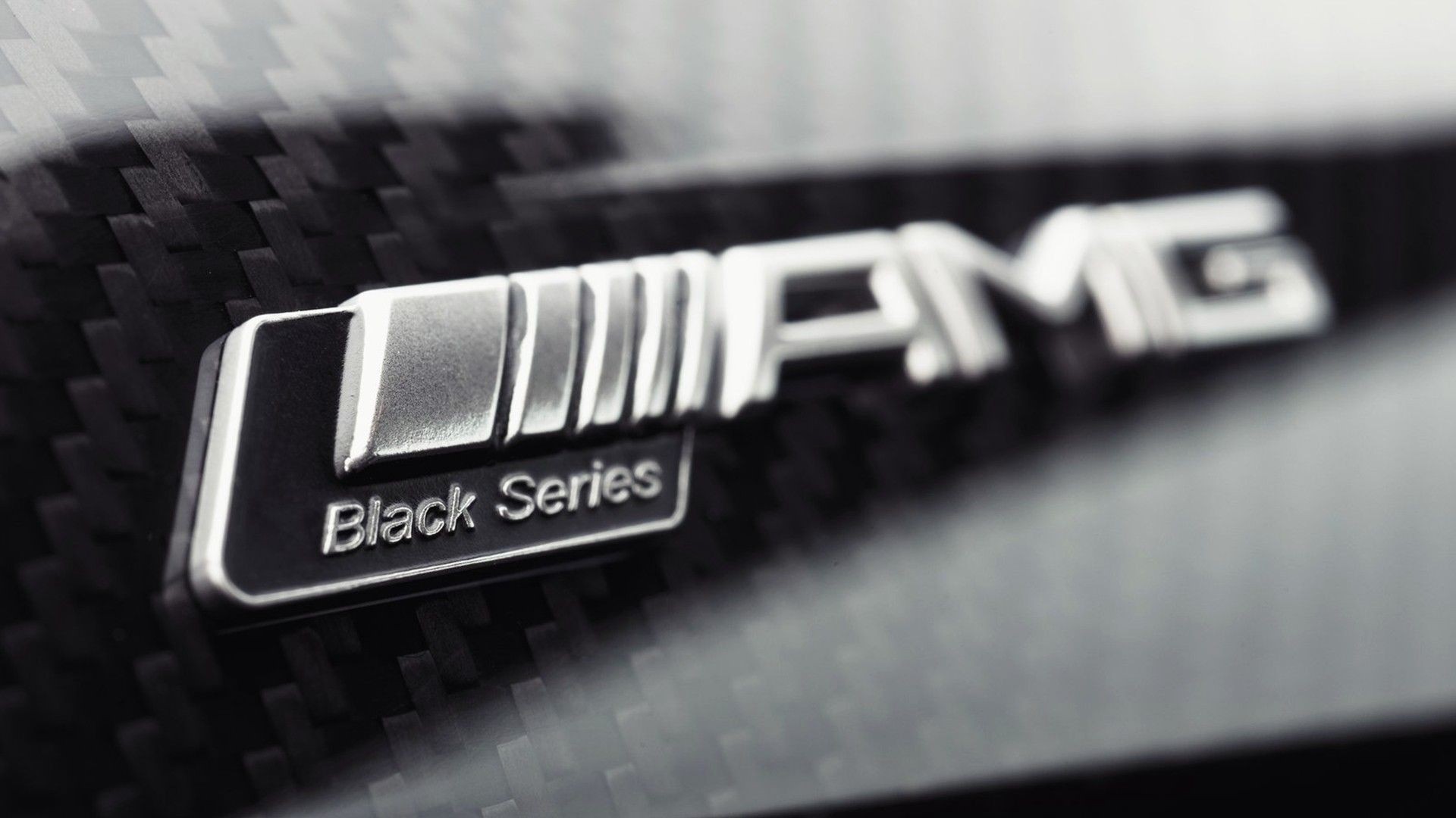Mercedes AMG Black Series emblem on carbon fiber HD Wallpaper