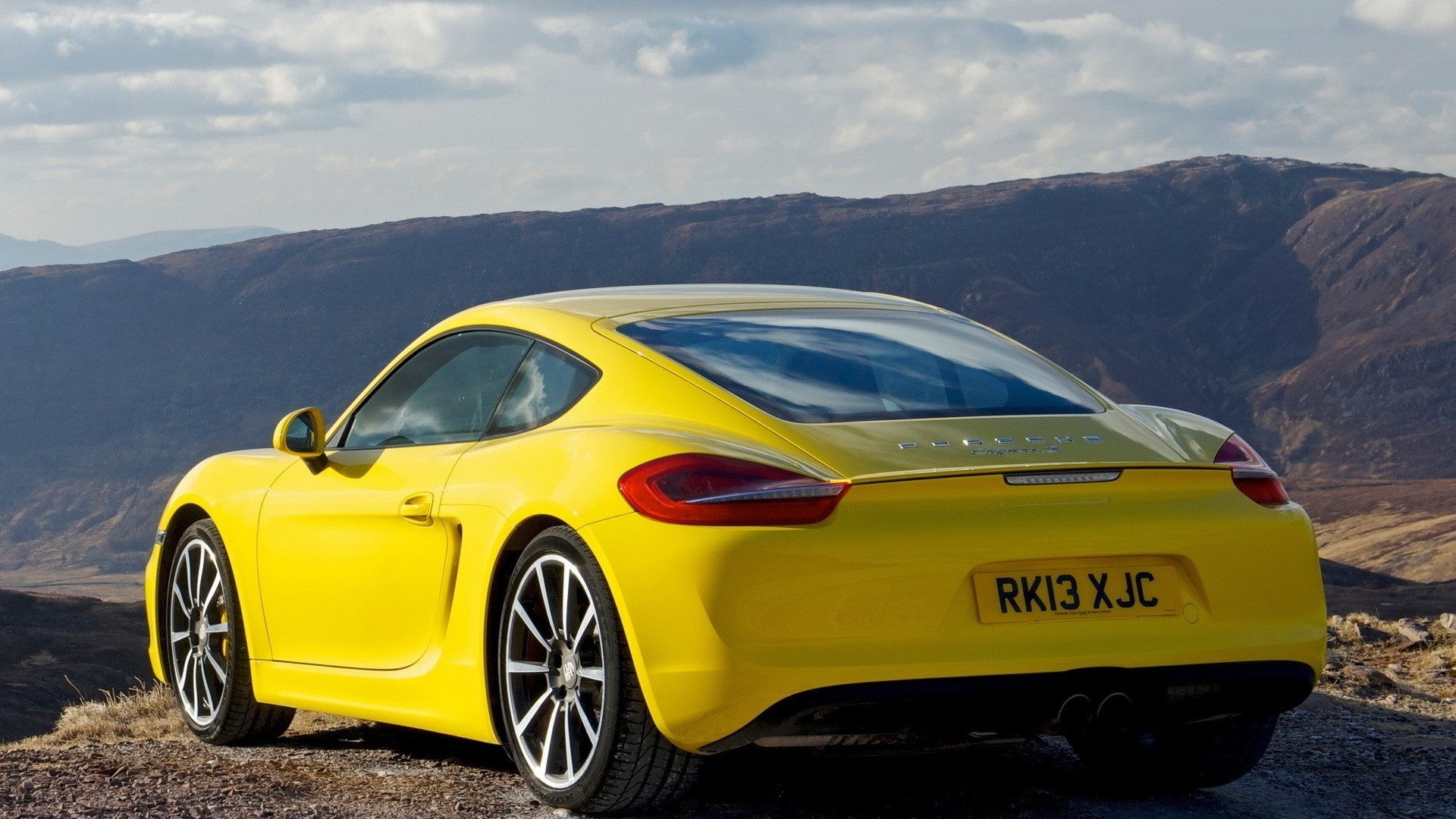 Yellow Porsche Cayman parked on a hill HD Wallpaper