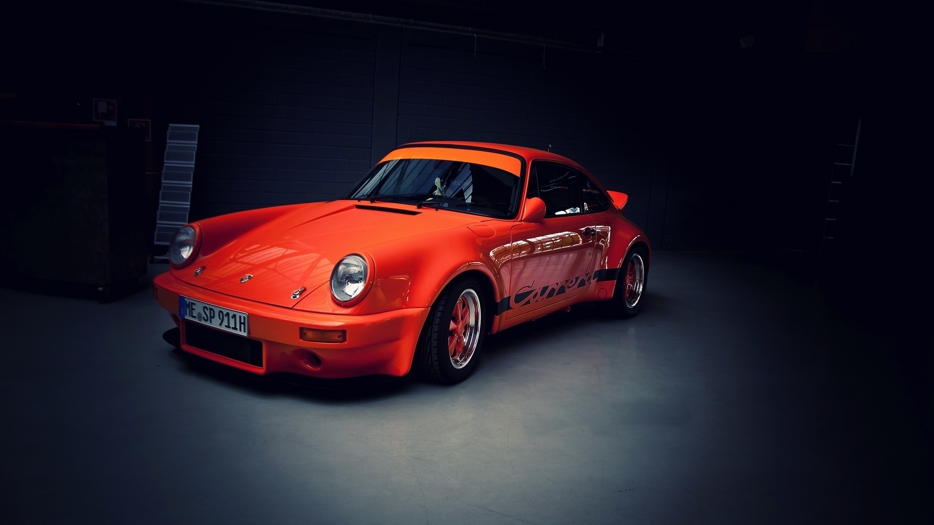Orange Porsche Carrera in a Garage HD Wallpaper