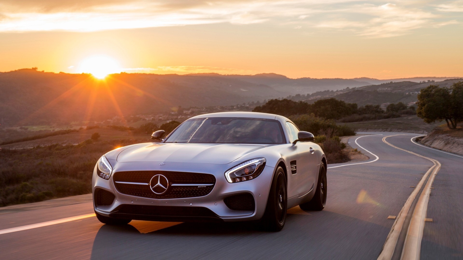 Mercedes-Benz AMG GT on a winding road at sunset HD Wallpaper