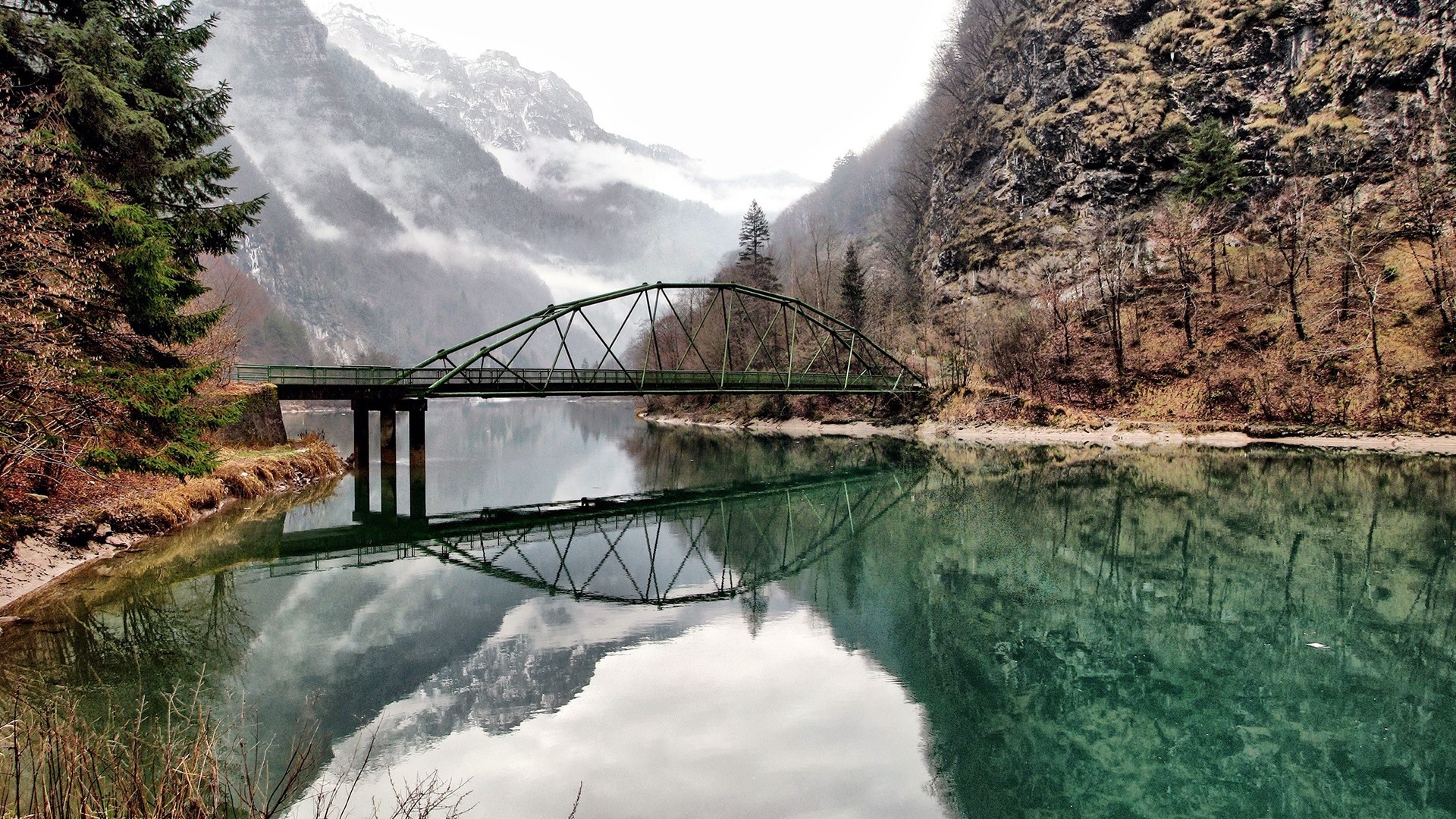 Bridge over a mountain lake in winter HD Wallpaper