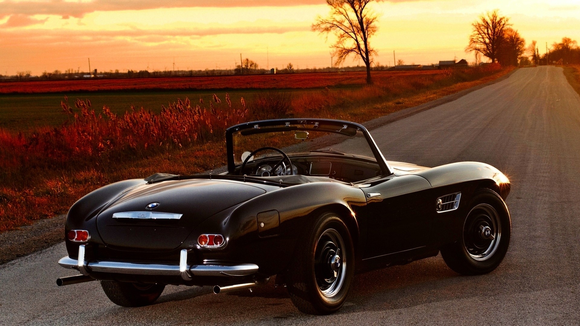 Black BMW 507 Roadster on a country road at sunset HD Wallpaper