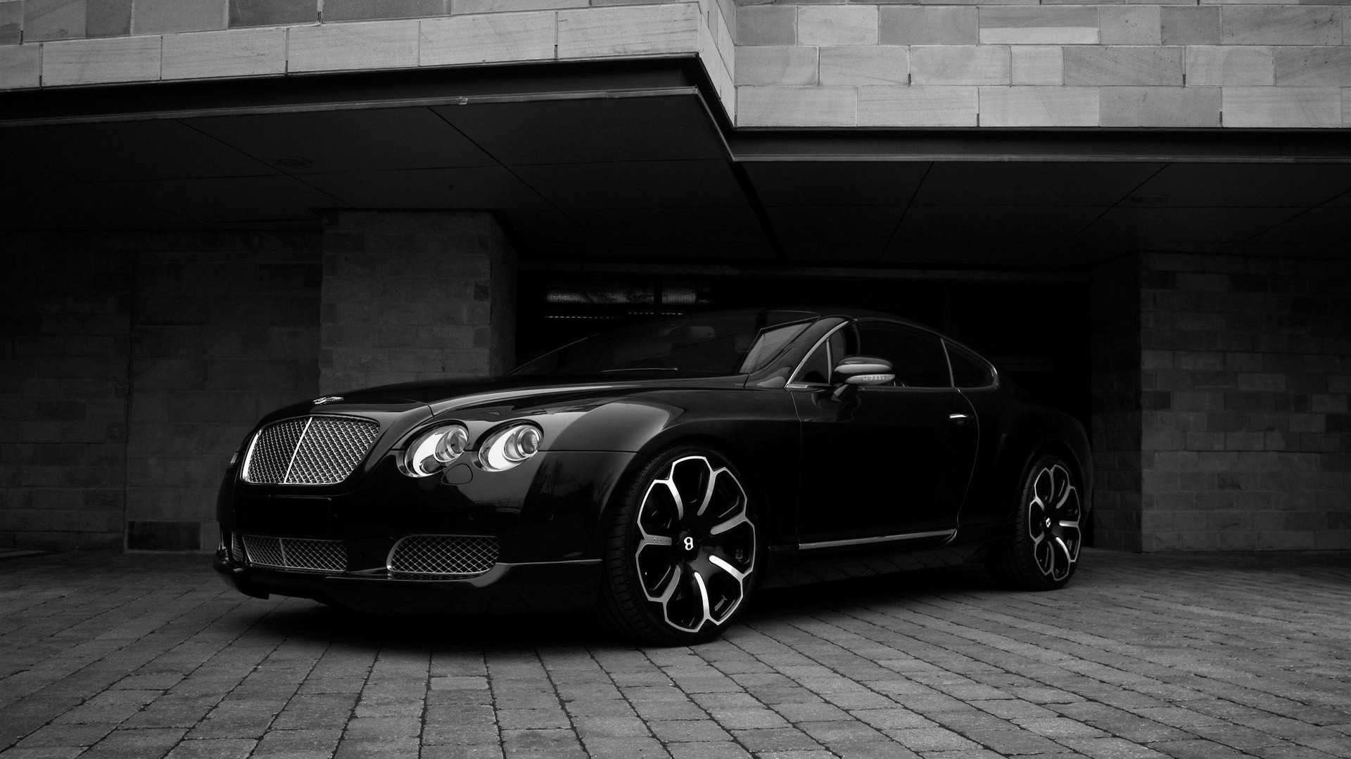 Black Bentley Continental GT parked under a building HD Wallpaper