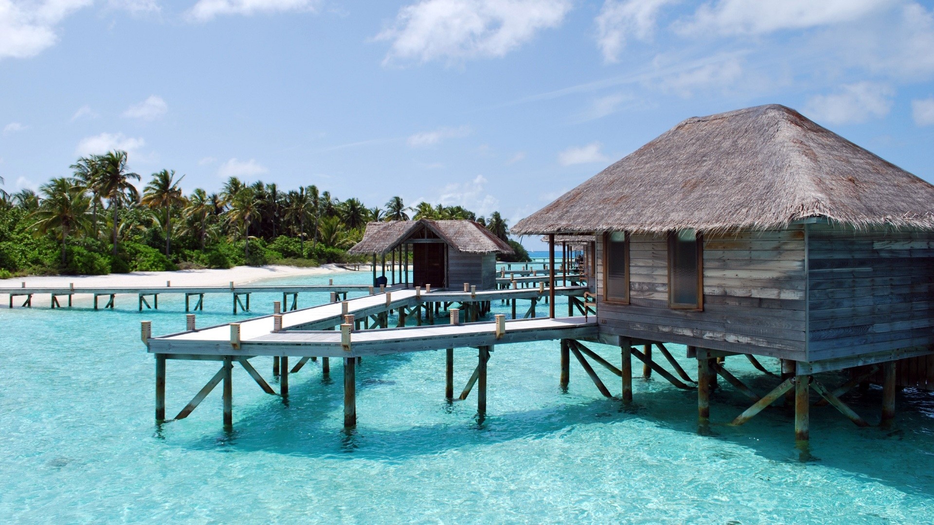 Overwater bungalows on a tropical island HD Wallpaper