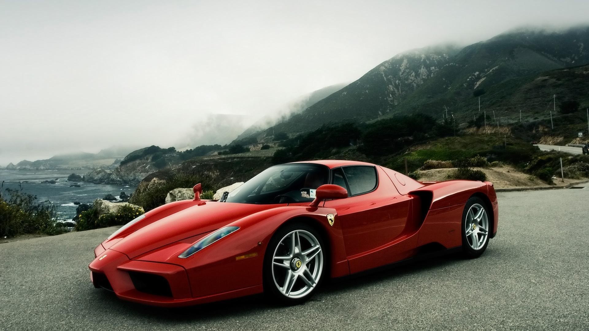 Red Ferrari Enzo on a coastal road HD Wallpaper