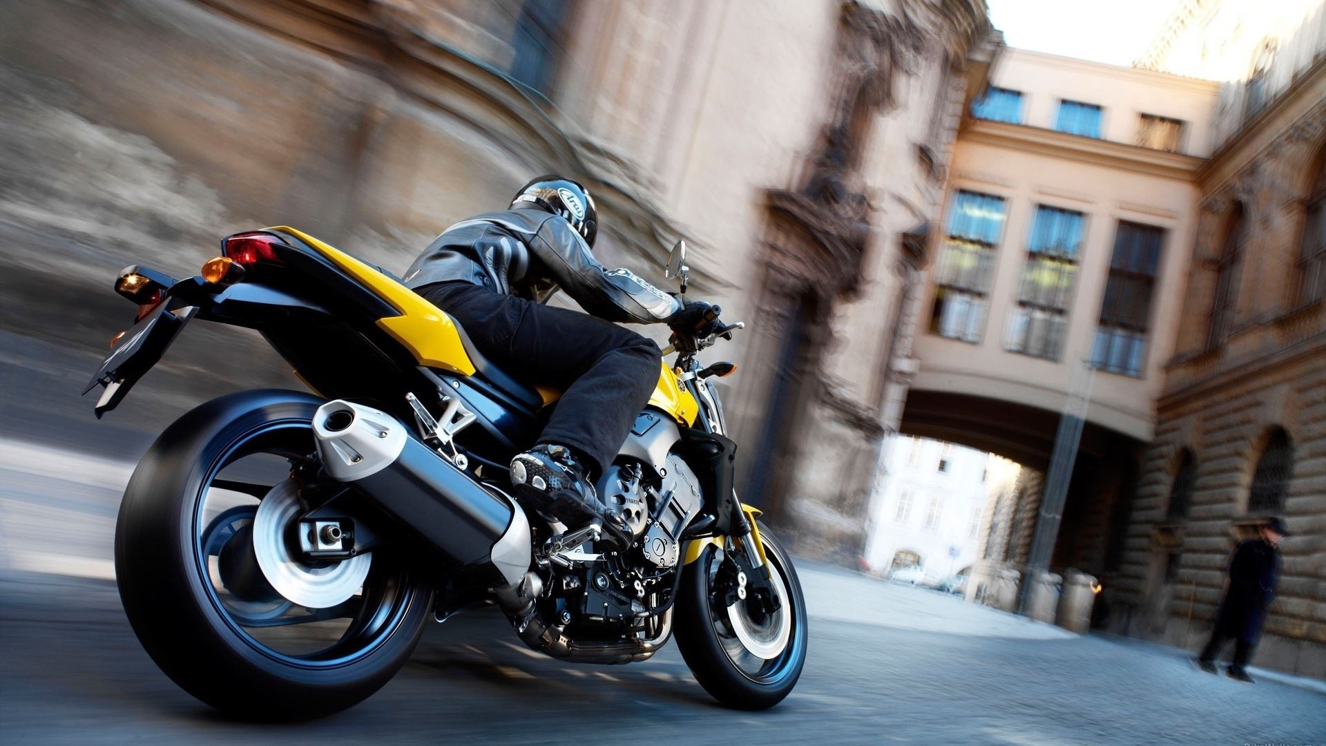 Yamaha motorcycle cruising through city streets HD Wallpaper