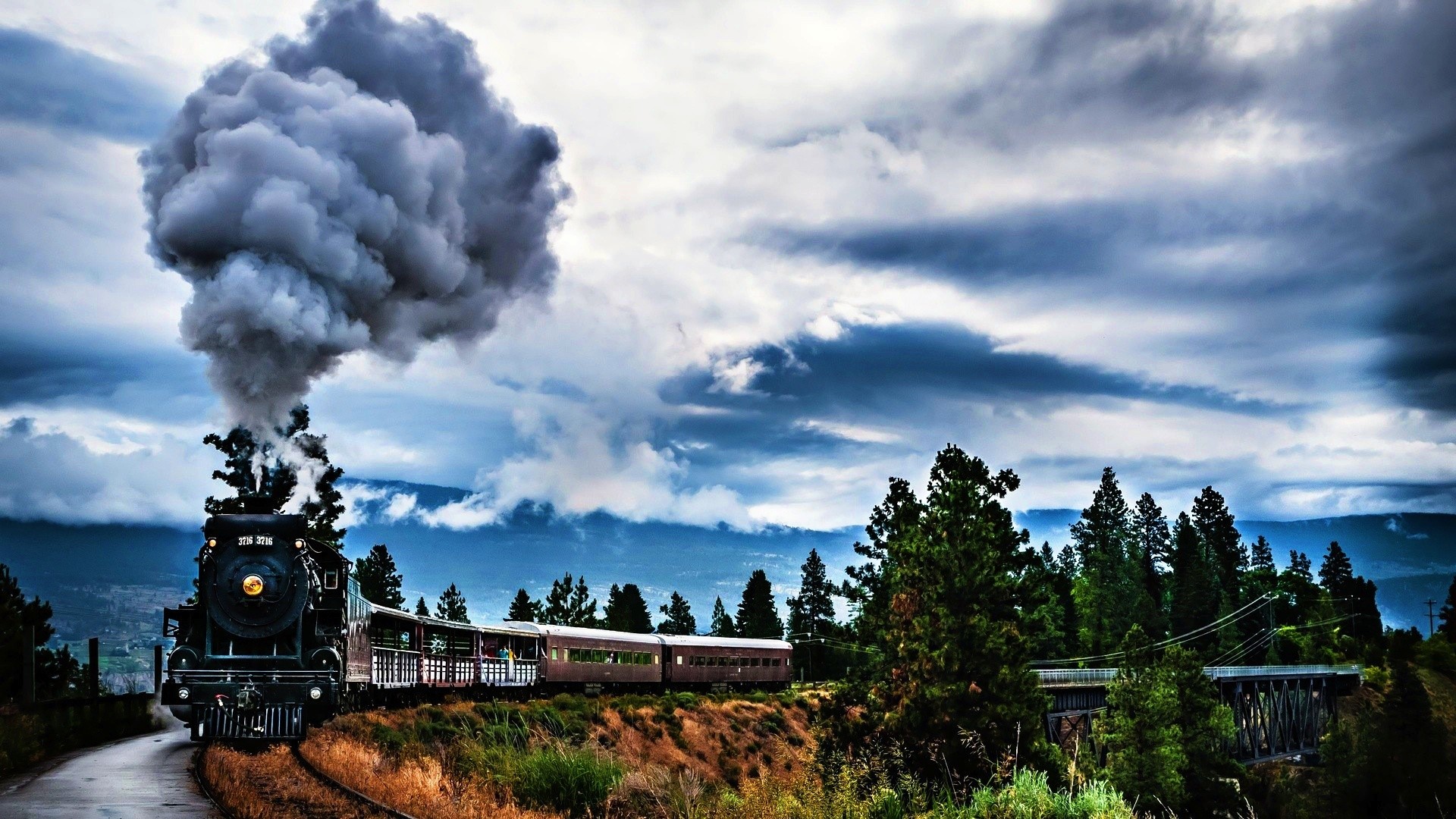 Old steam locomotive with dark clouds HD Wallpaper
