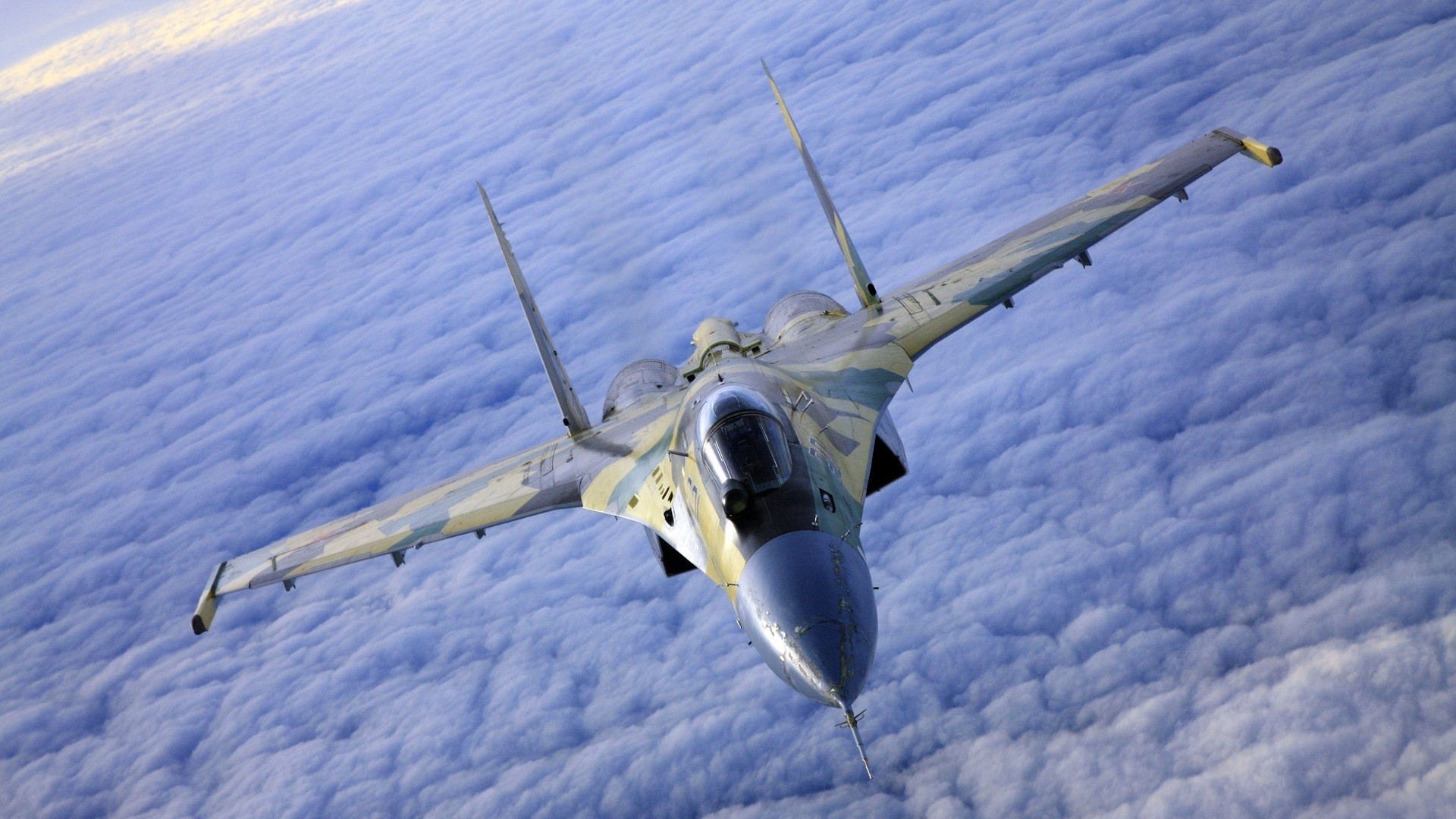 Sukhoi Su-37 fighter jet flying over clouds HD Wallpaper