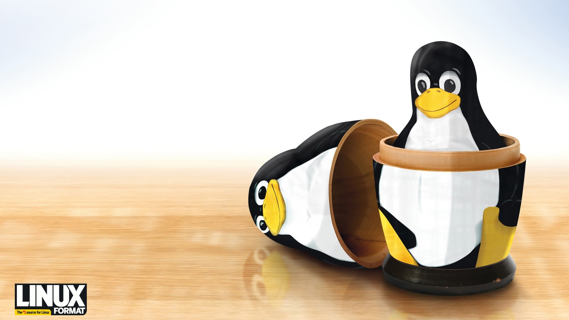 Linux Tux Nesting Dolls on Wooden Surface HD Wallpaper