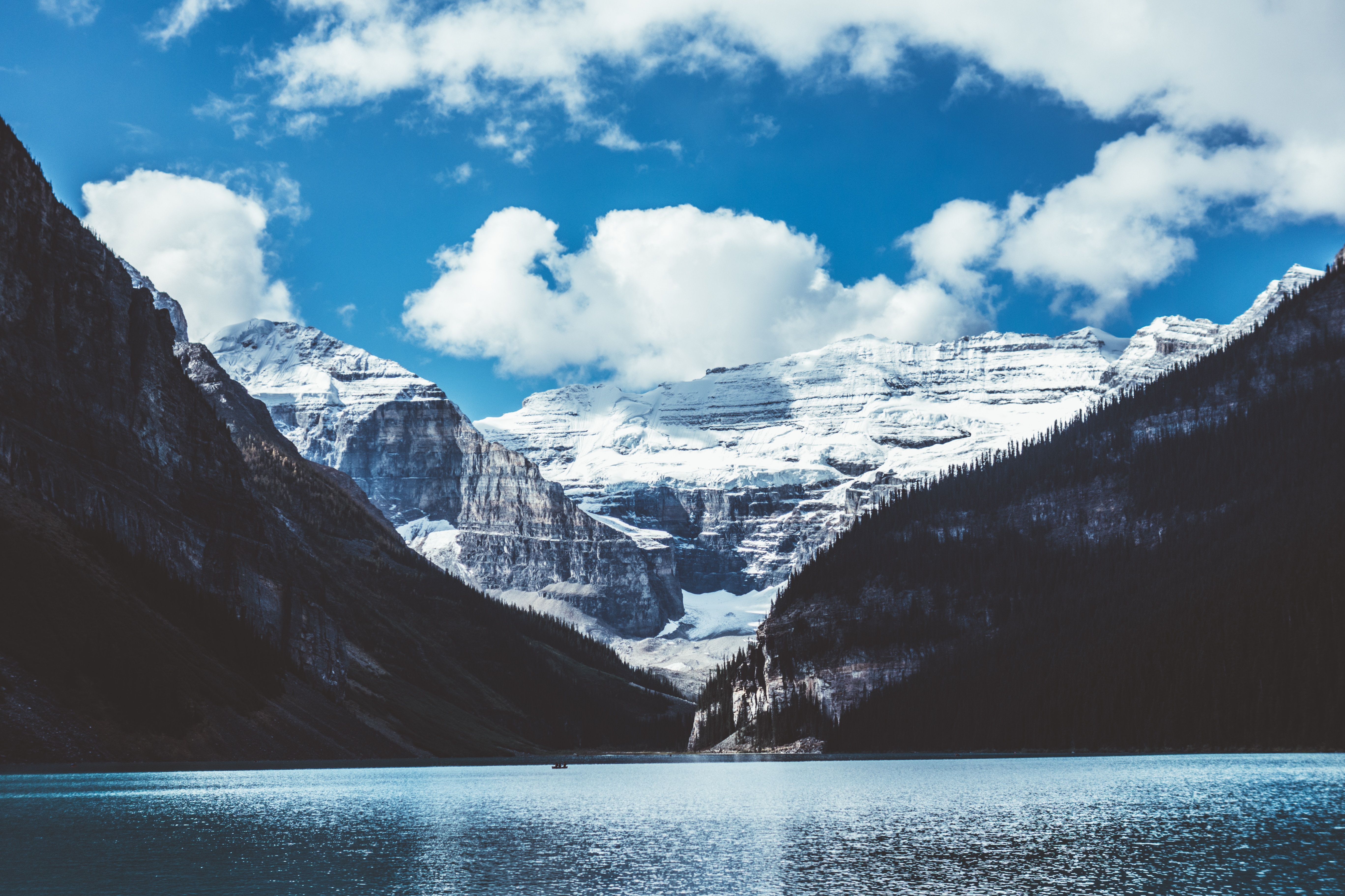 Snow-capped mountains overlooking a lake HD Wallpaper