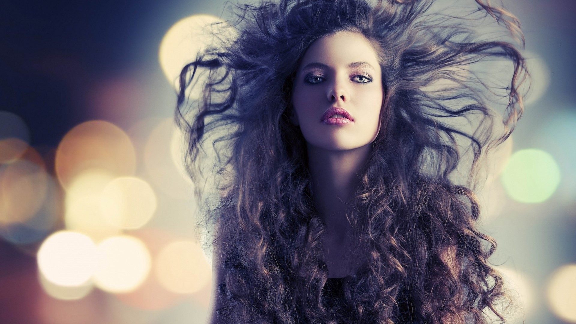 Fashionable woman with long curly hair and bokeh background HD Wallpaper