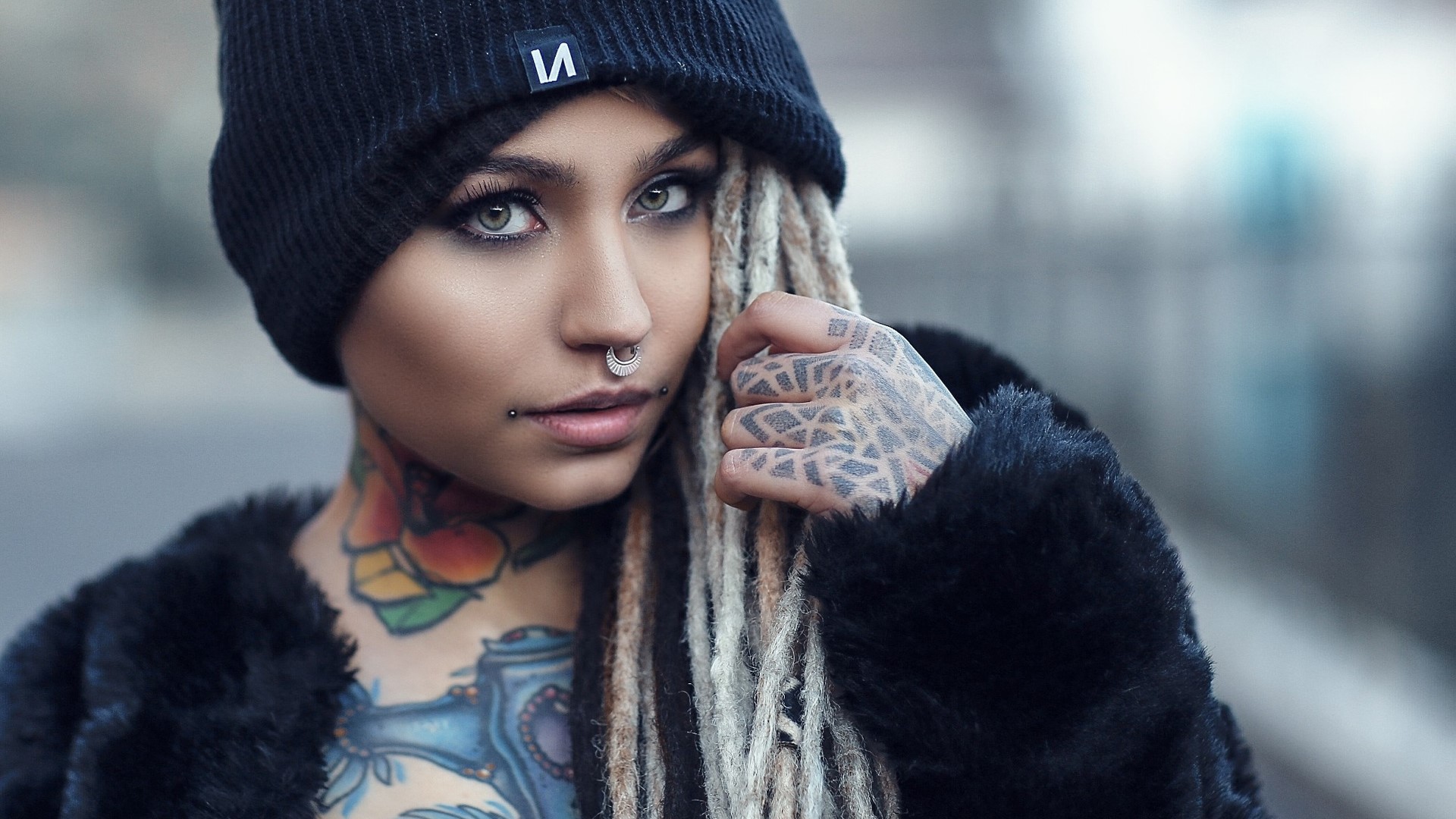 Woman with tattoos and nose rings wearing a beanie HD Wallpaper