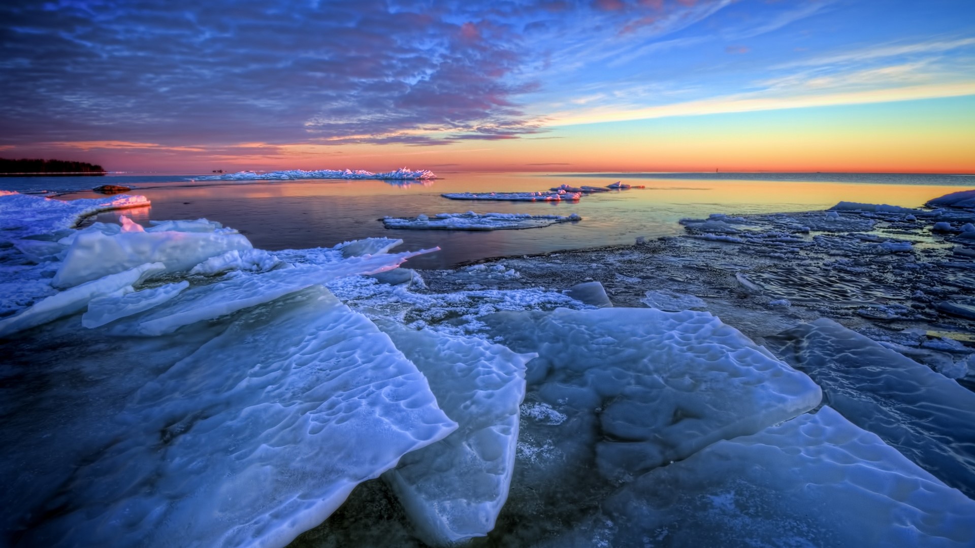 Sunset over a frozen sea with ice floes HD Wallpaper