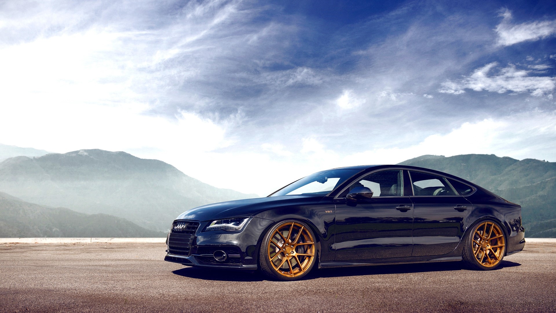 Black Audi A7 with gold rims on a road HD Wallpaper