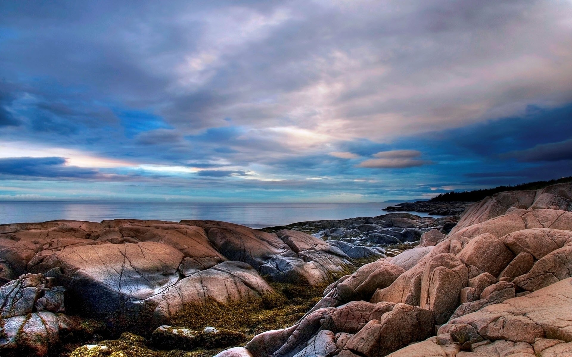 Rocky coastline with dramatic clouds over the ocean HD Wallpaper