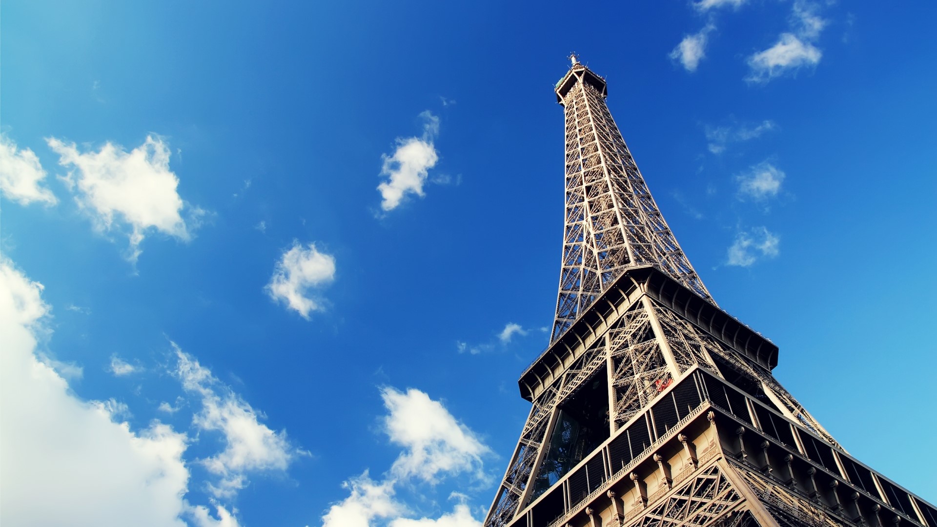 Eiffel Tower in Paris under a blue sky HD Wallpaper