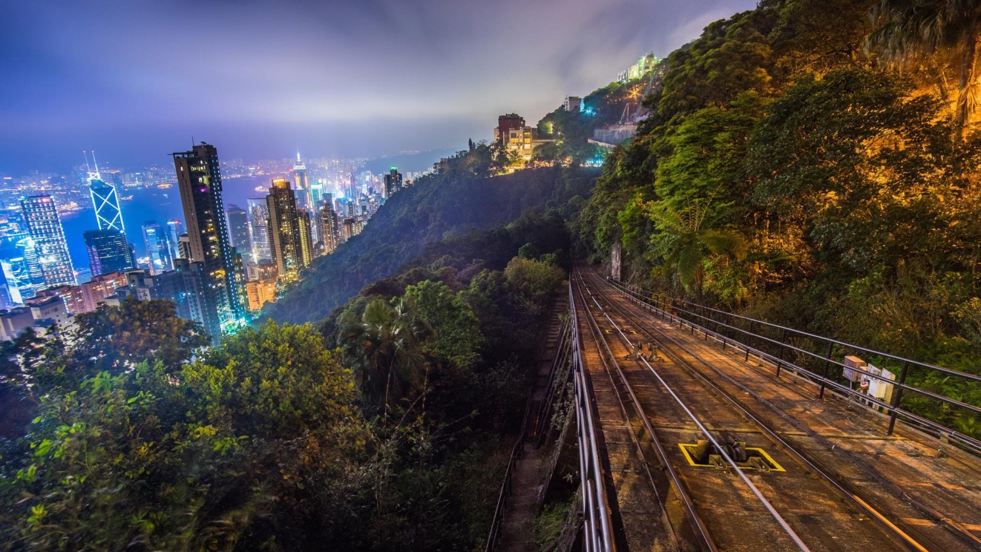 Hong Kong skyline and tram tracks at night HD Wallpaper