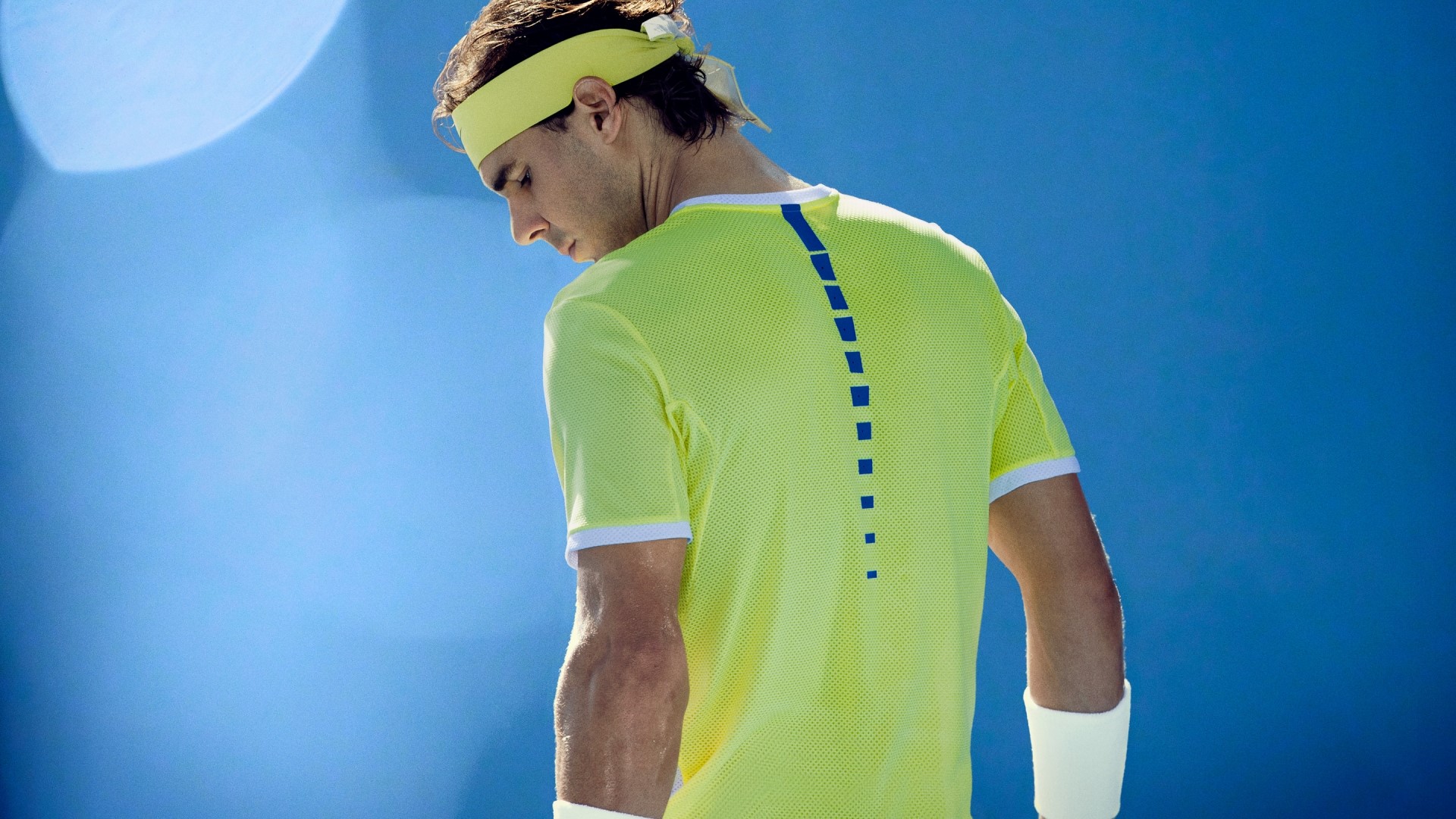 Rafael Nadal wearing a yellow shirt and headband HD Wallpaper