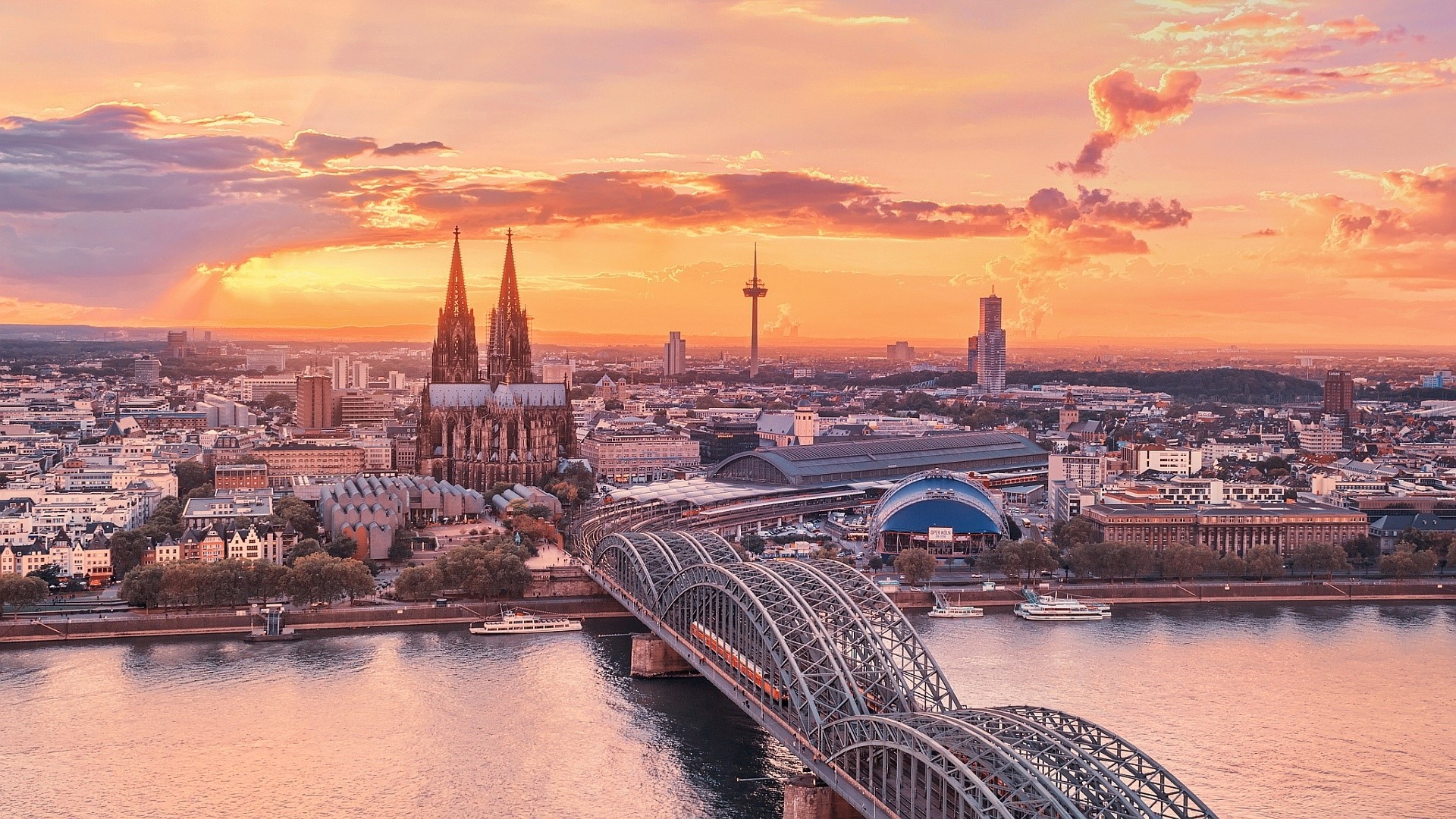 Cologne Cathedral and Hohenzollern Bridge at sunset HD Wallpaper