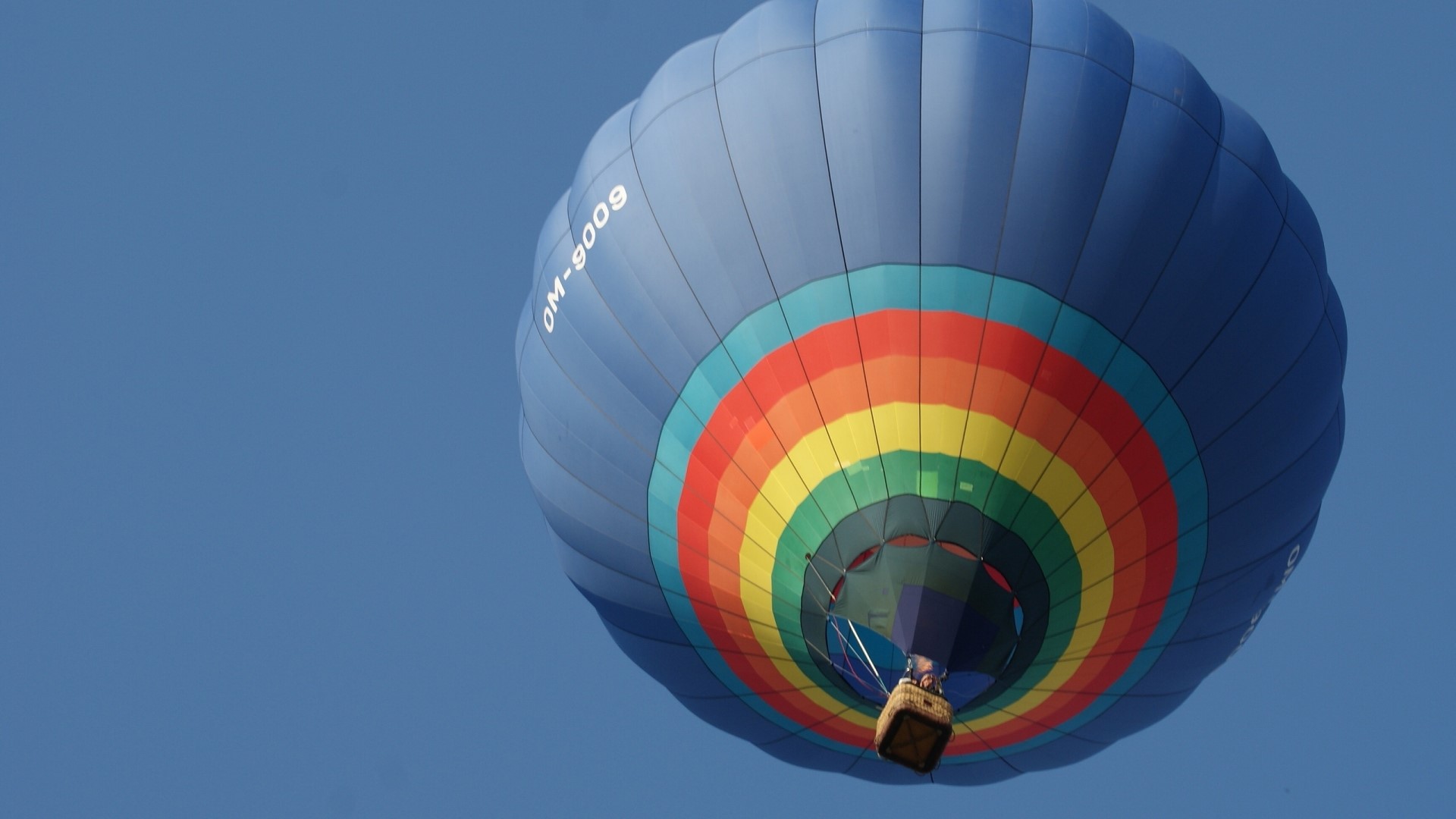 Blue hot air balloon with rainbow stripes HD Wallpaper