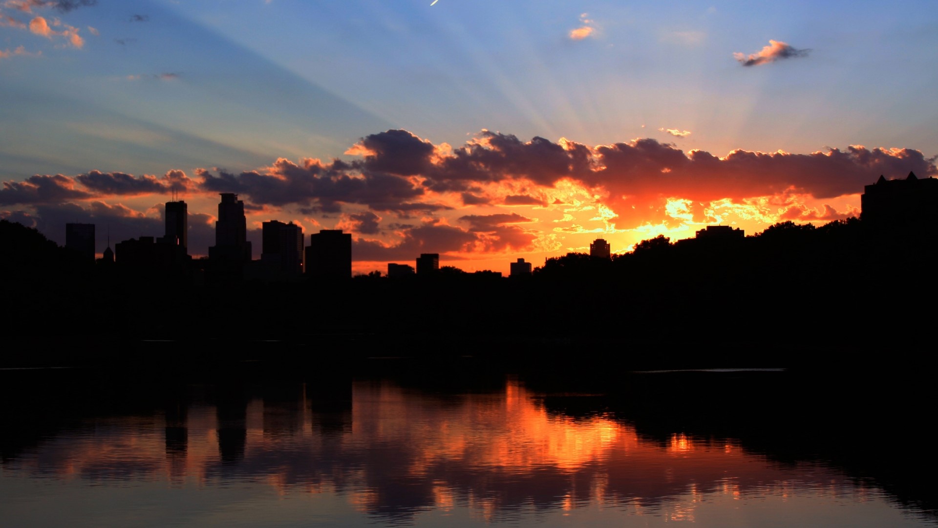 Minneapolis skyline at sunset over water HD Wallpaper