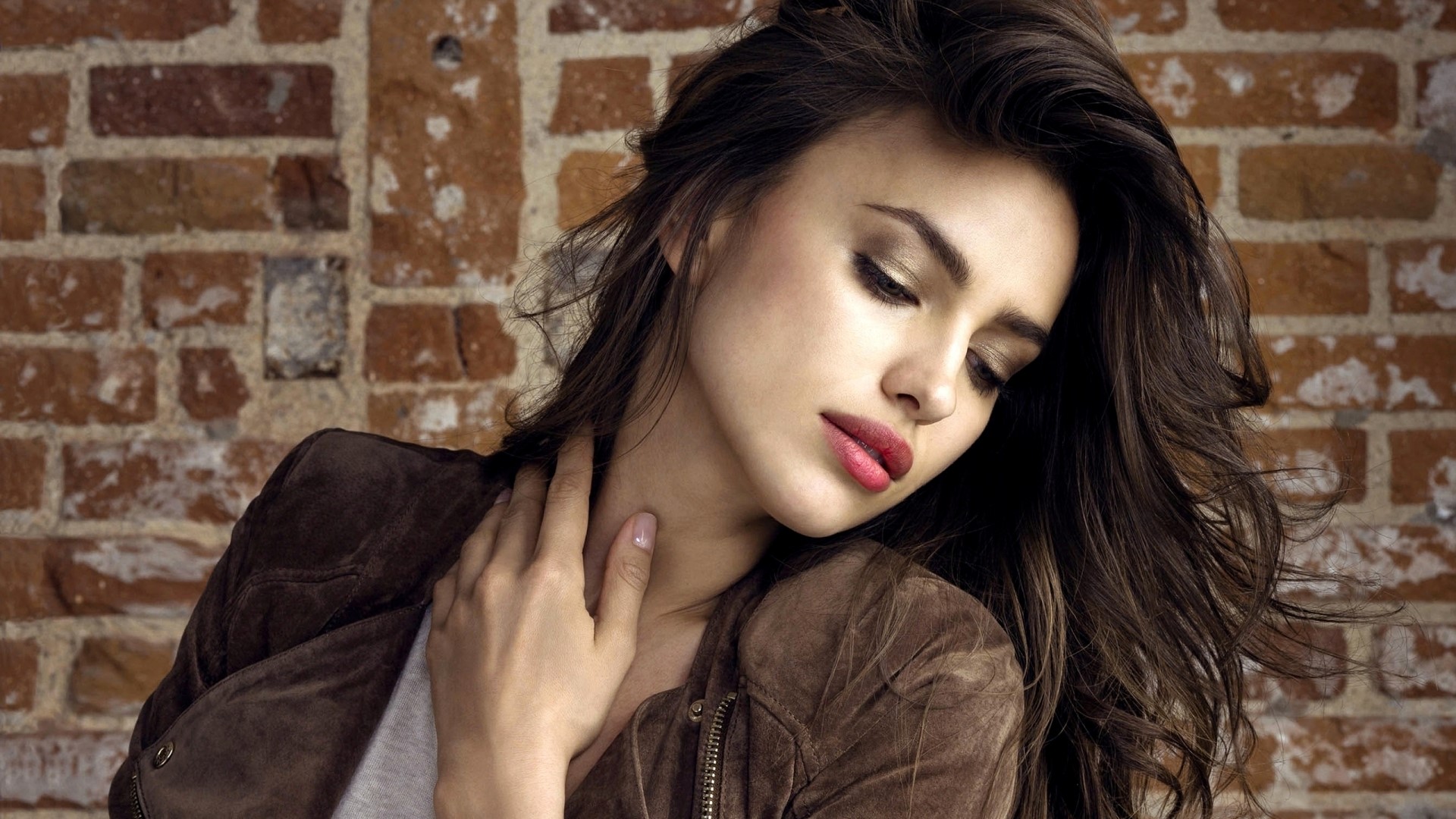 Irina Shayk posing against a brick wall HD Wallpaper