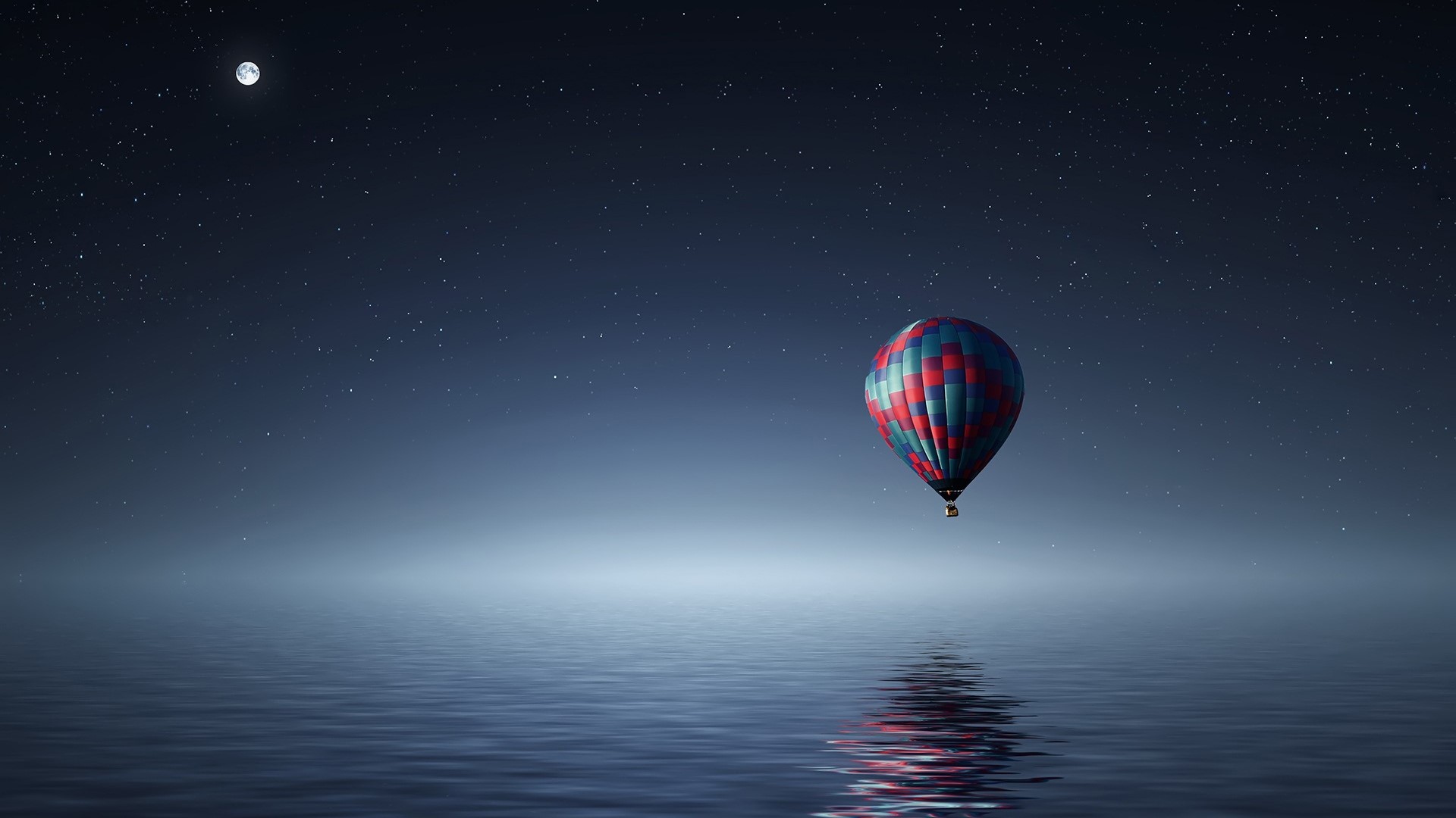 Hot air balloon over the sea at night HD Wallpaper