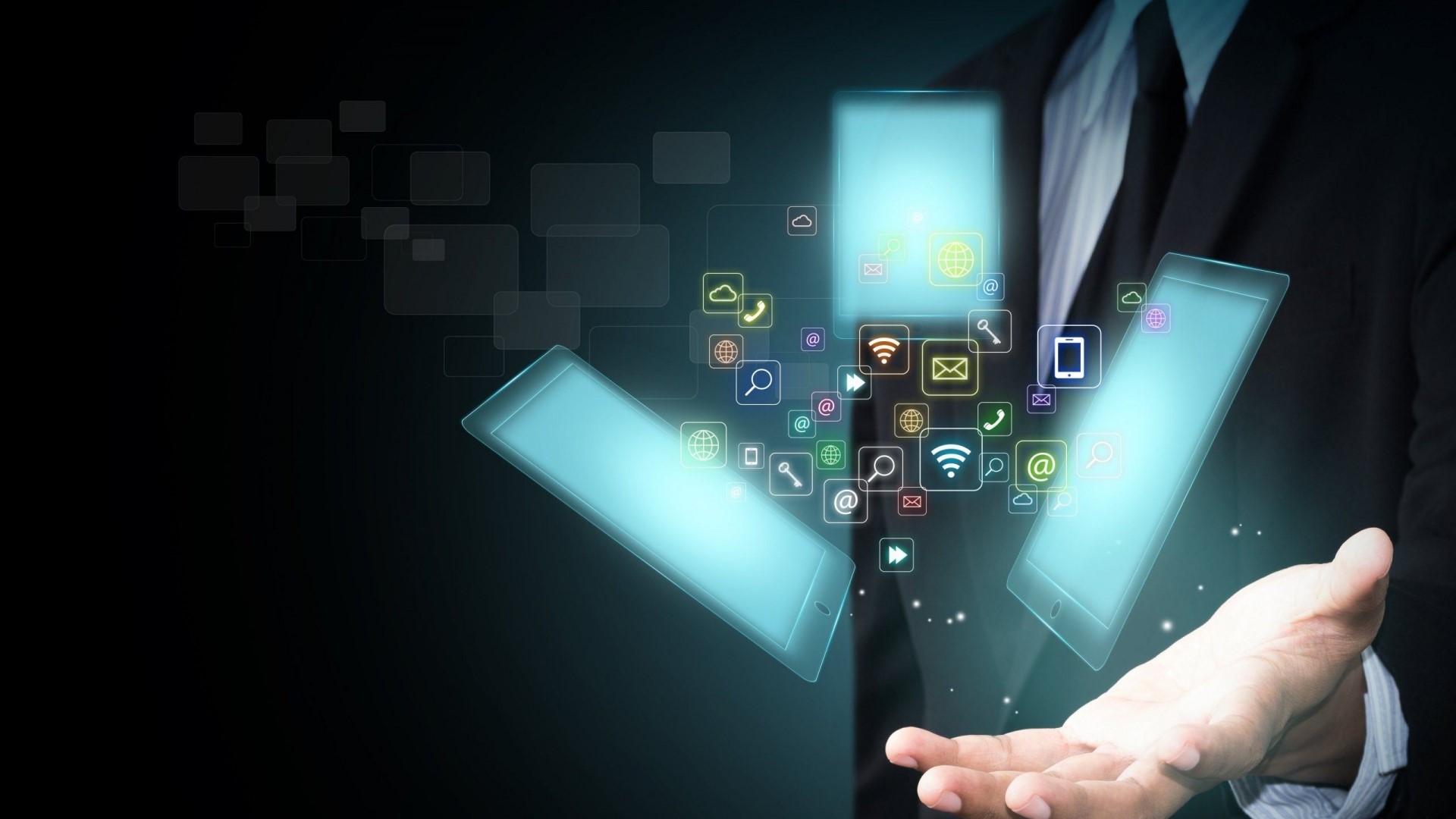 Man in suit holding tablets with app icons HD Wallpaper