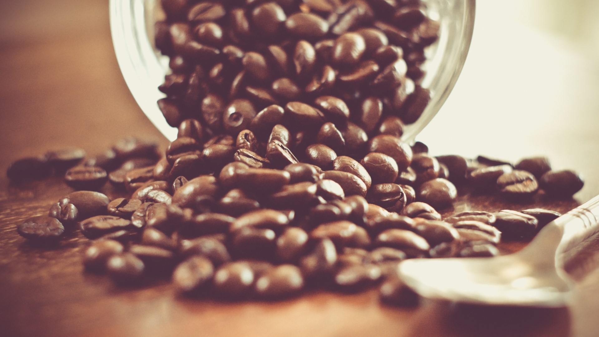 Coffee beans spilling from a jar HD Wallpaper