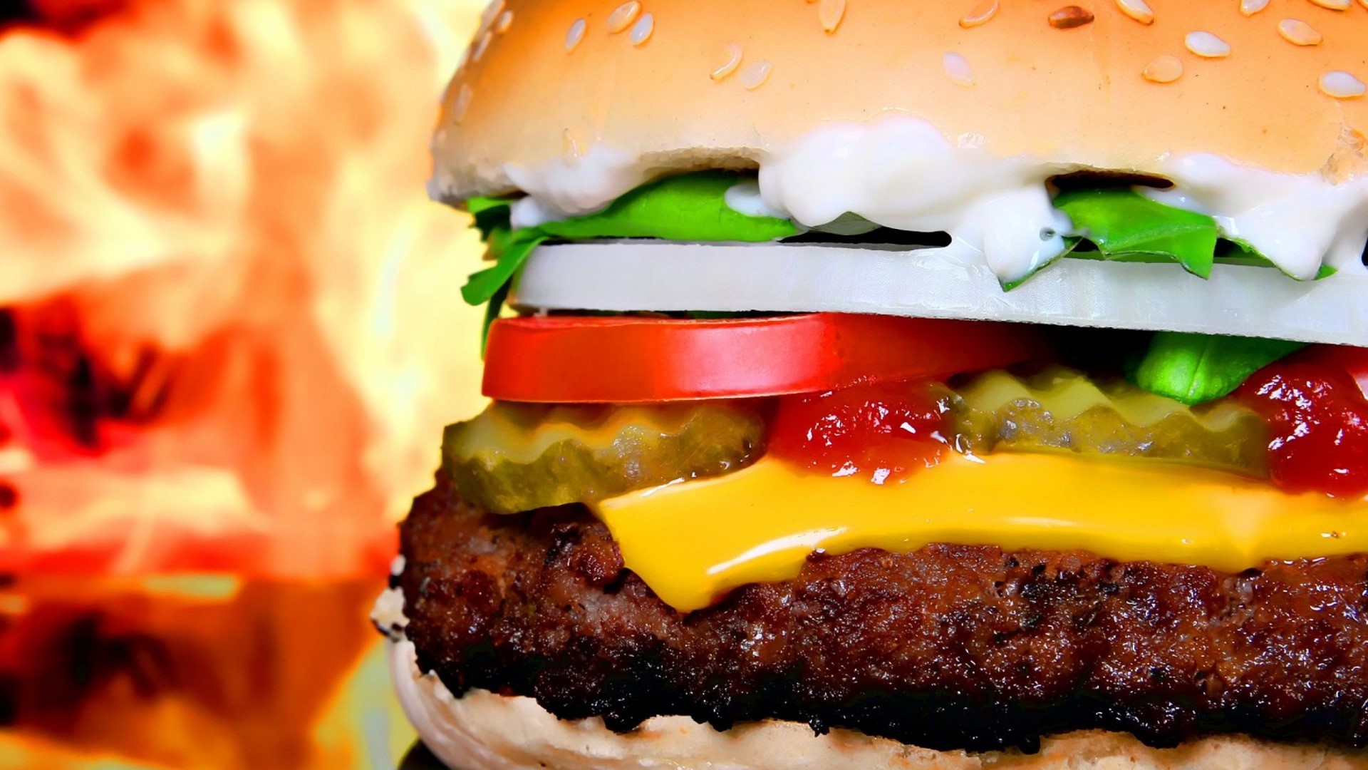 Close-up of a delicious hamburger with flames in the background HD Wallpaper