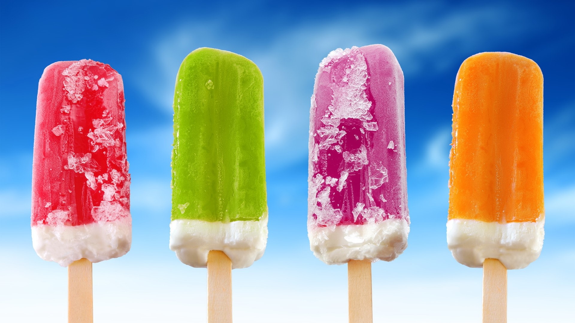 Four colorful ice pops on sticks against a blue sky HD Wallpaper