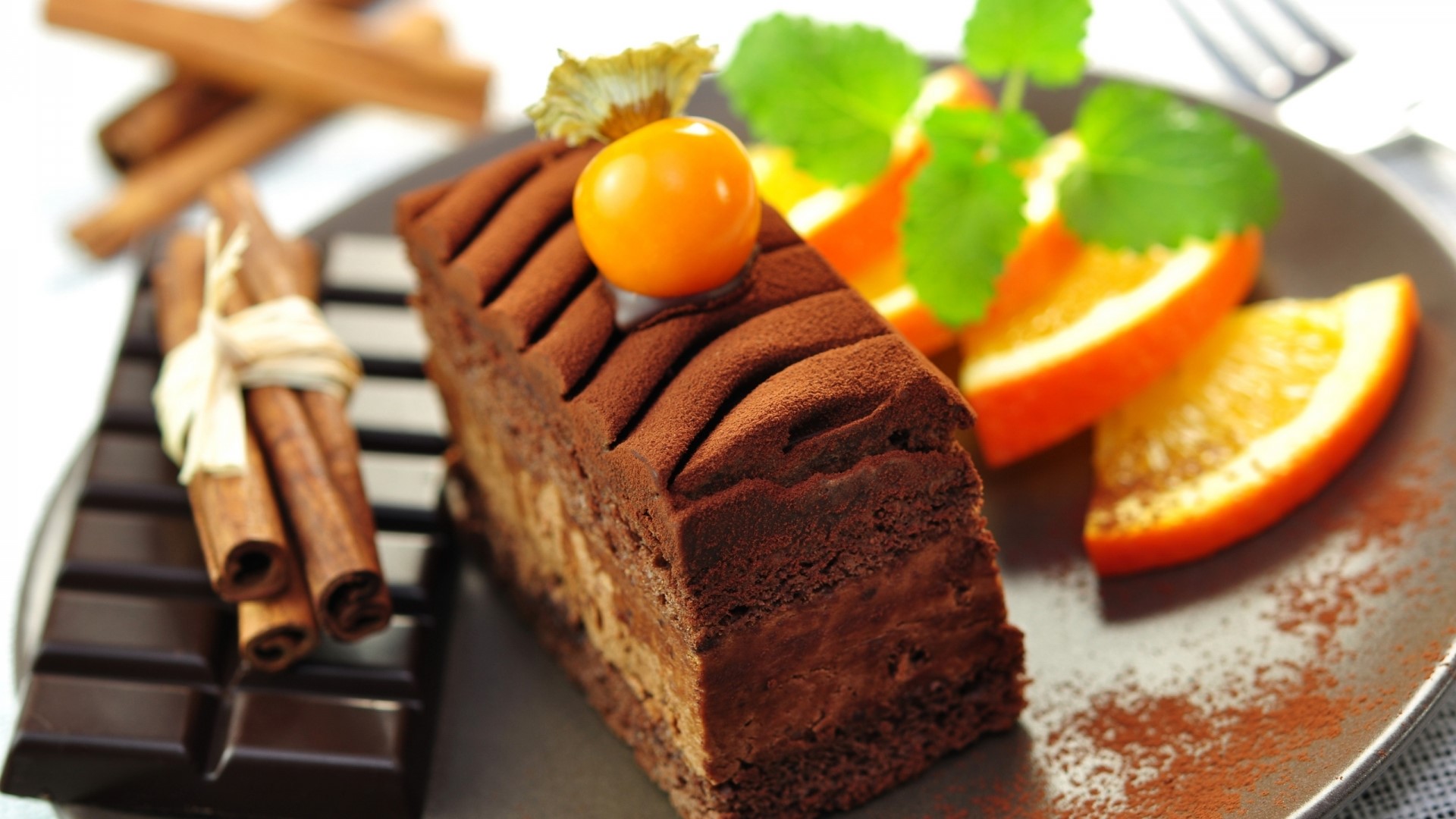 Chocolate cake with oranges and cinnamon sticks HD Wallpaper