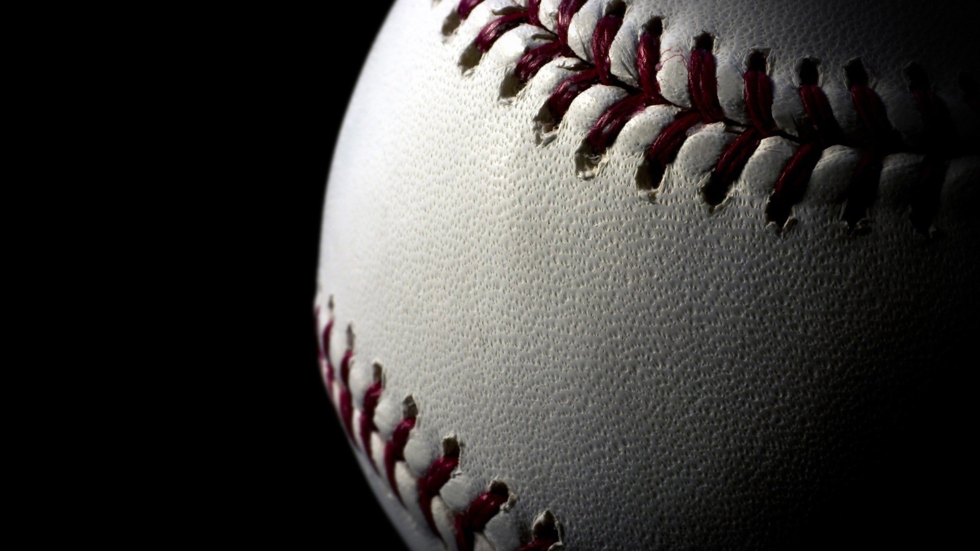 Close-up of a baseball with red stitching HD Wallpaper