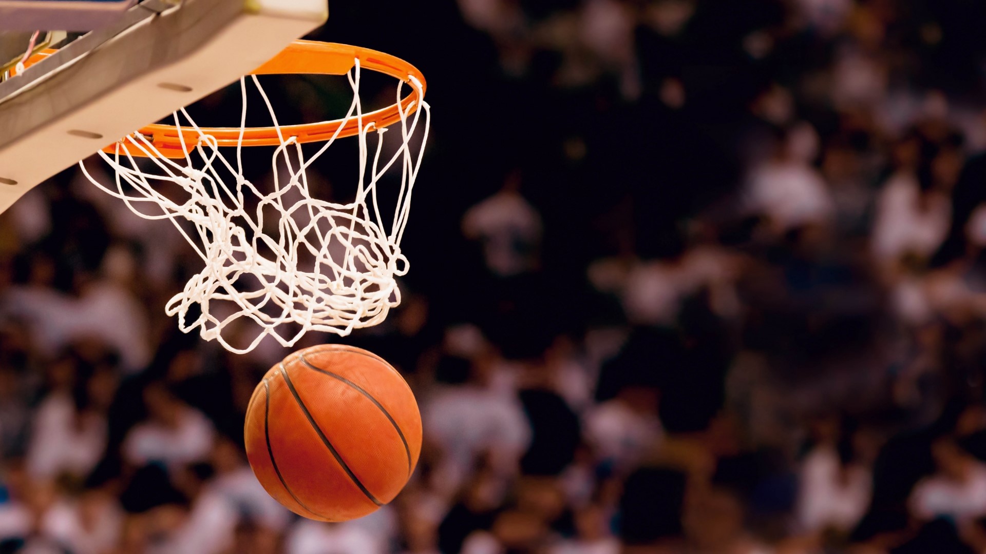 Basketball going through a hoop HD Wallpaper