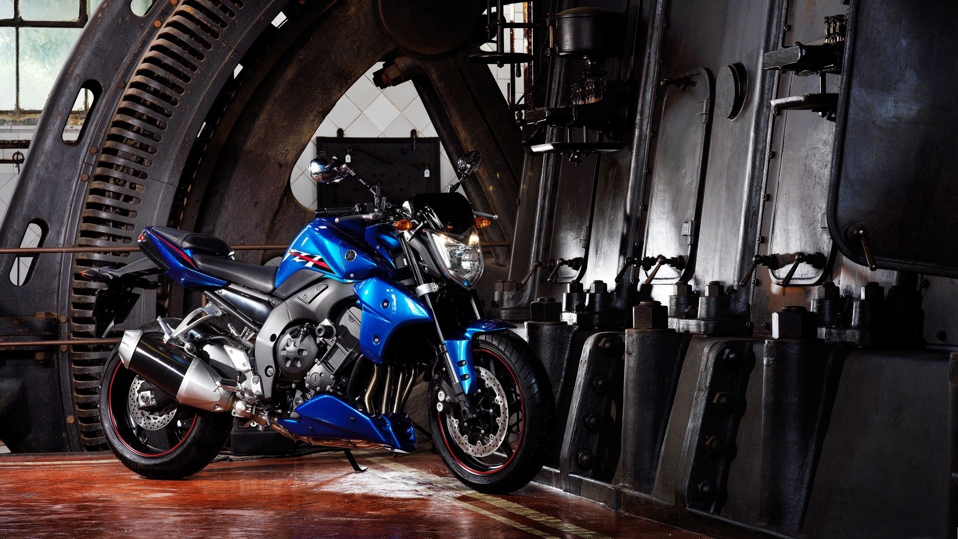Blue Yamaha motorcycle in industrial setting HD Wallpaper